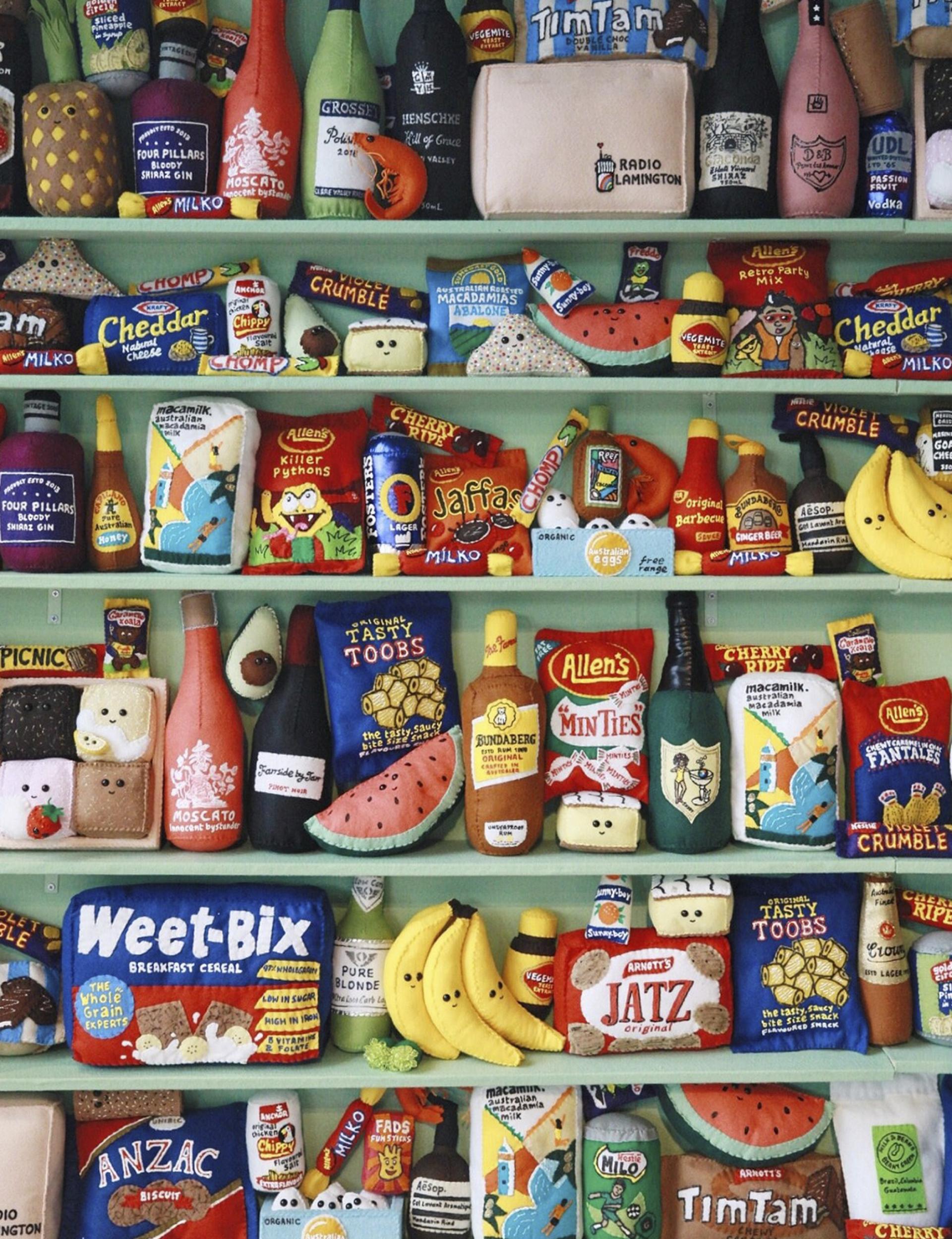 Colorful display of plush food items and beverages on shelves, reflecting Miami-inspired decor at Bondi Green dining venue.