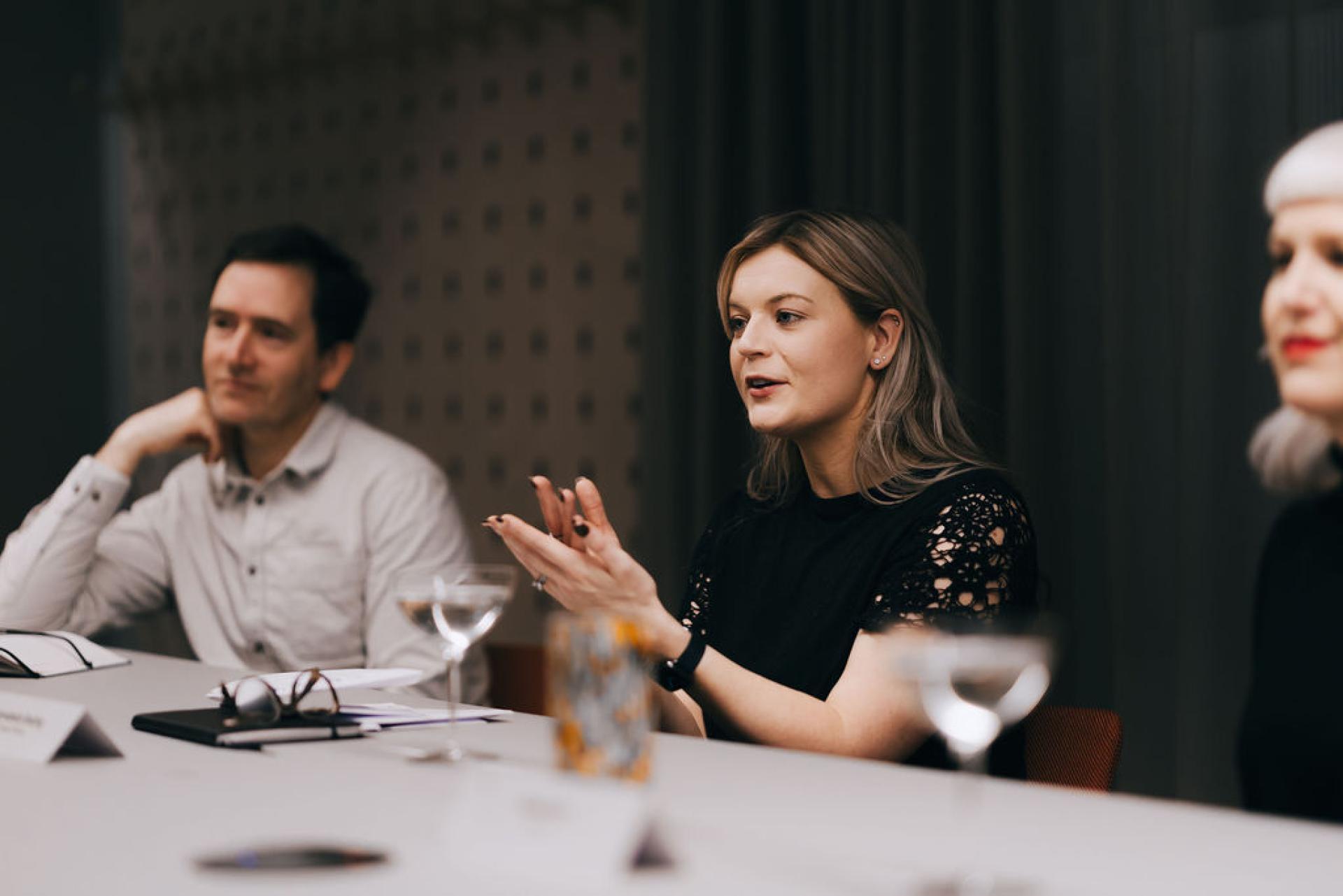 Participants discussing biomaterials and sustainability during a roundtable event at a modern meeting space.