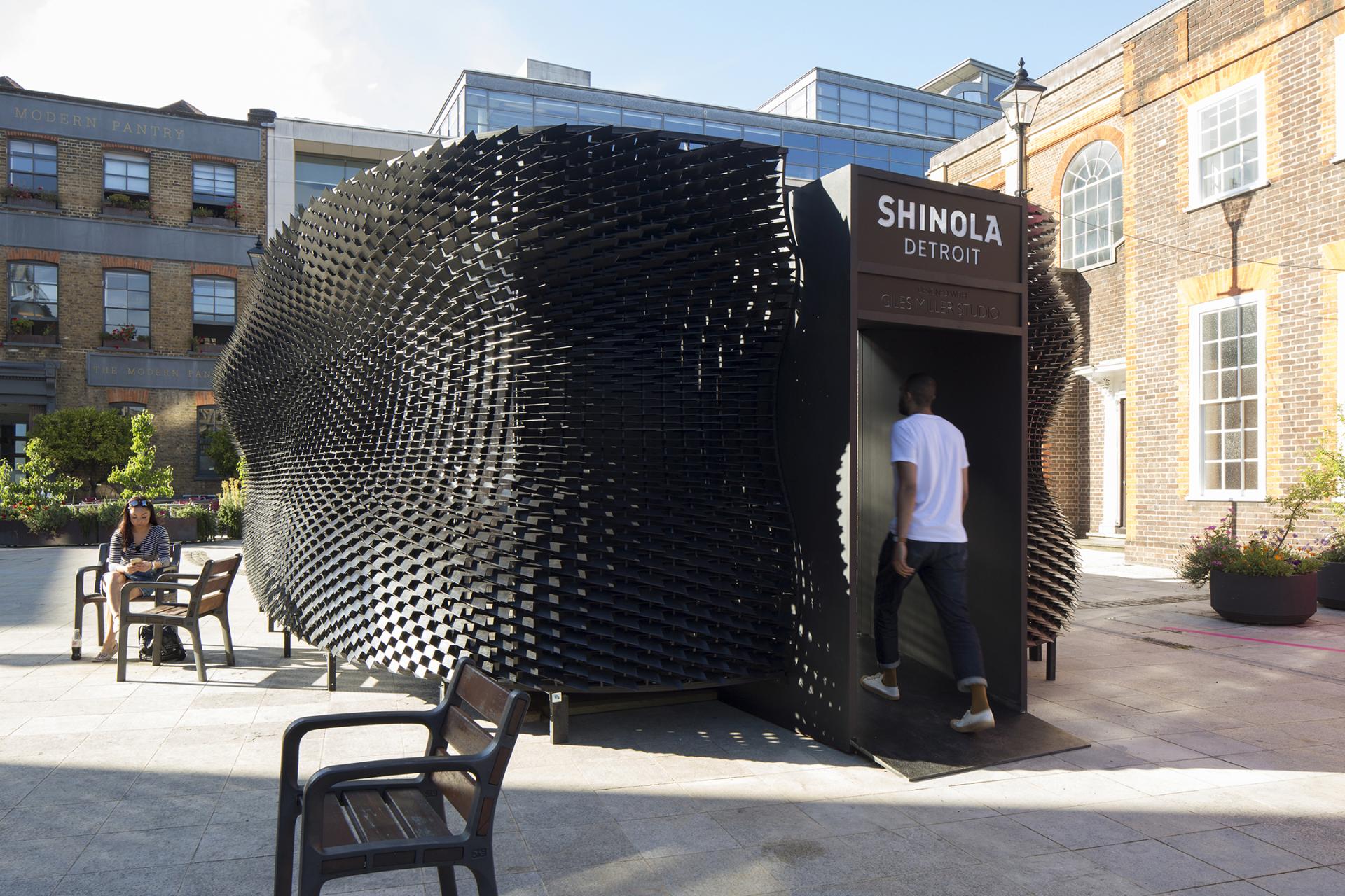 Contemporary art installation by Giles Miller, featuring an intricate black façade, inviting exploration and creative interaction.