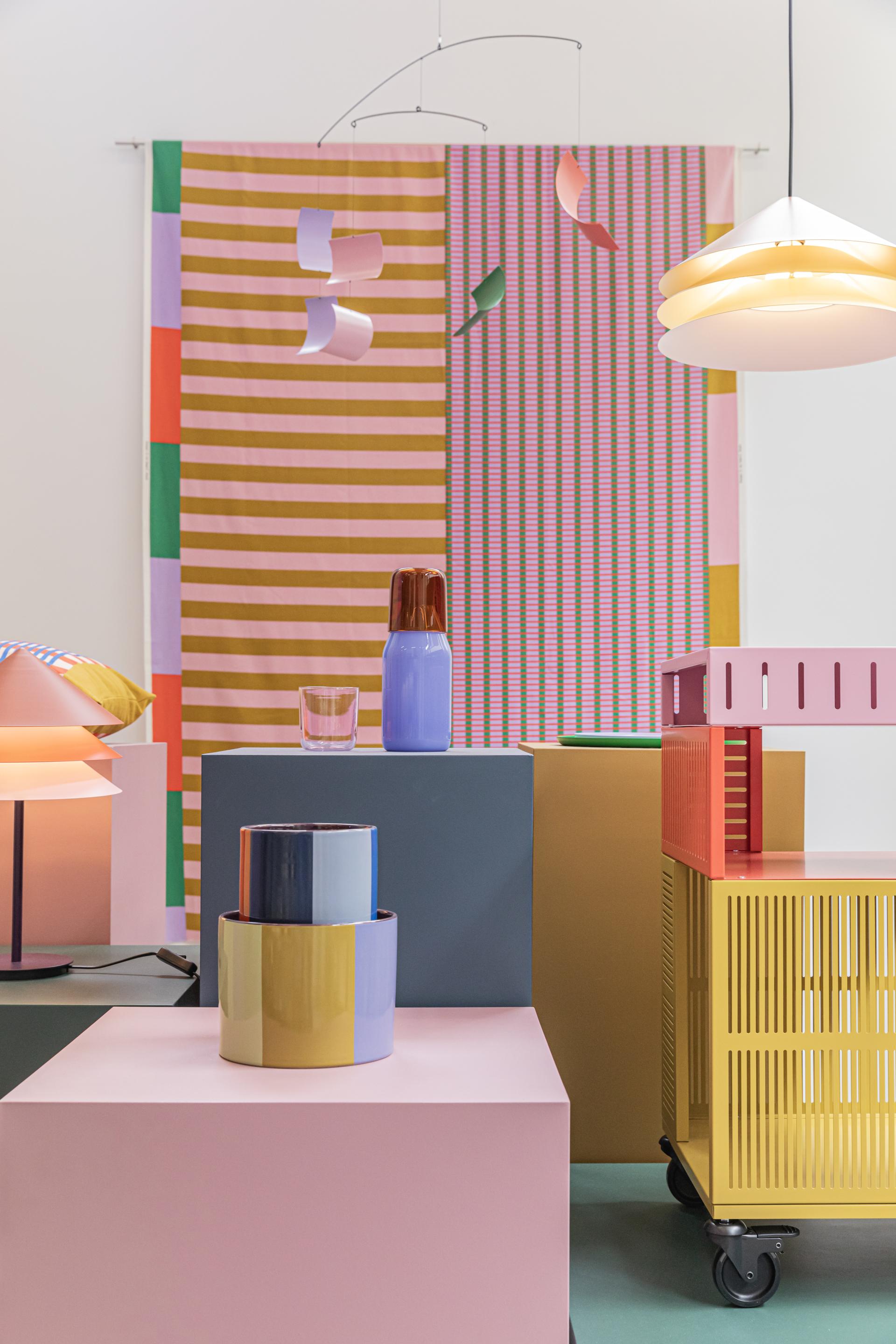 Vibrant display of Dutch design featuring colorful ceramics, modern light fixtures, and patterned textiles at Dutch Design Week 2024.