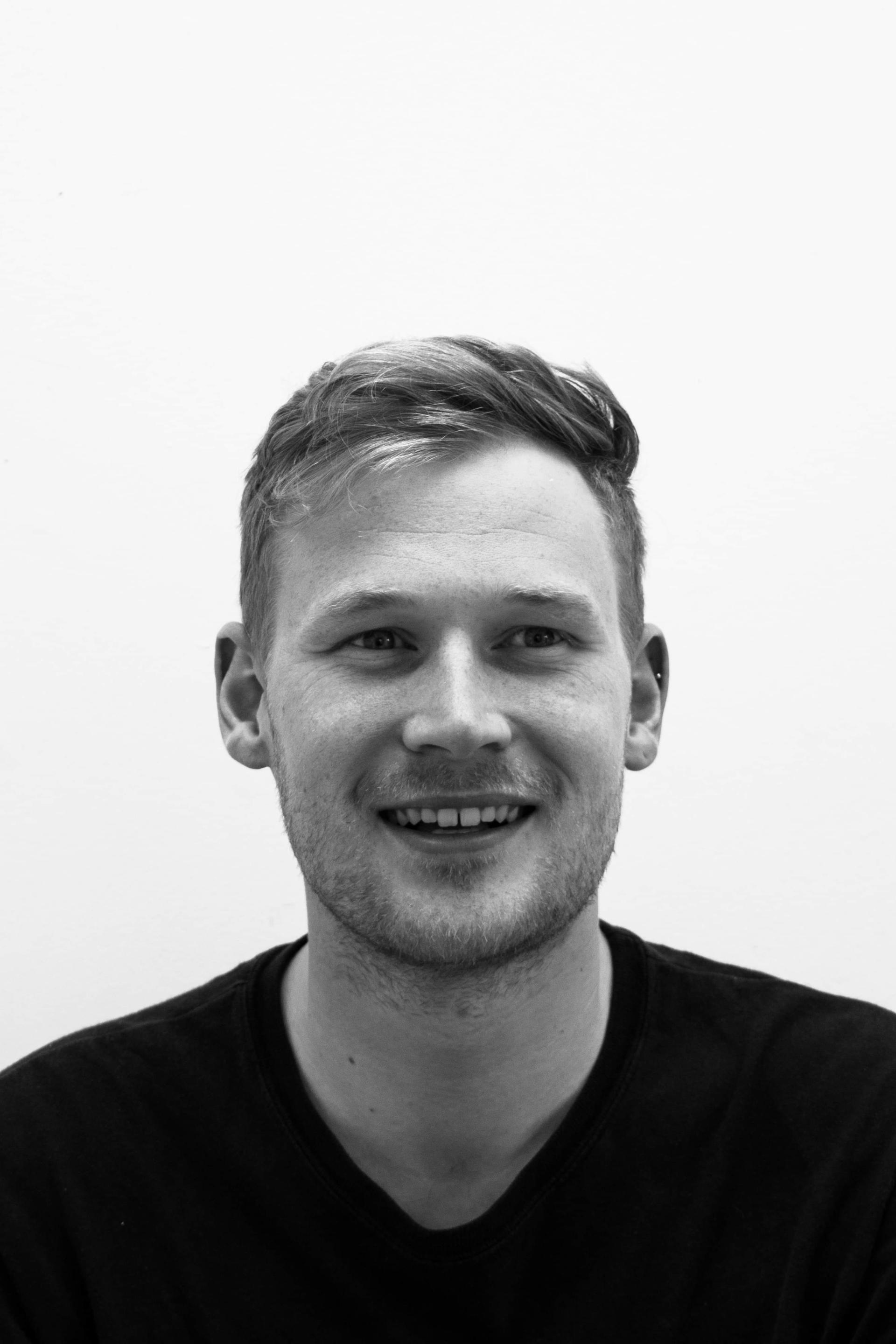 Gavin Stanley Keightley smiling in a black shirt, embodying his design ethos inspired by natural erosion elements.