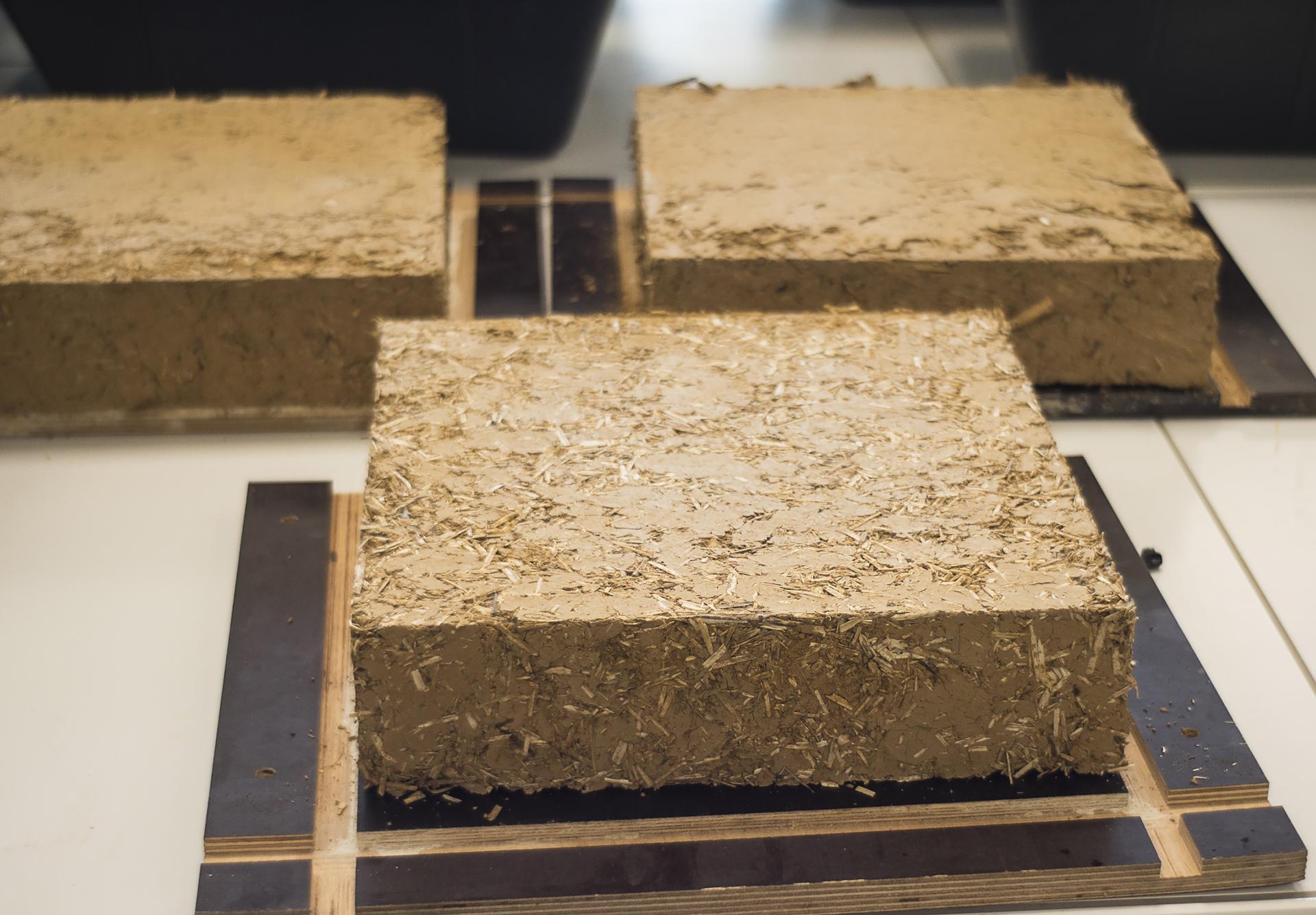 Cob blocks made from a mixture of earth and natural fibers, used in traditional cob house construction.