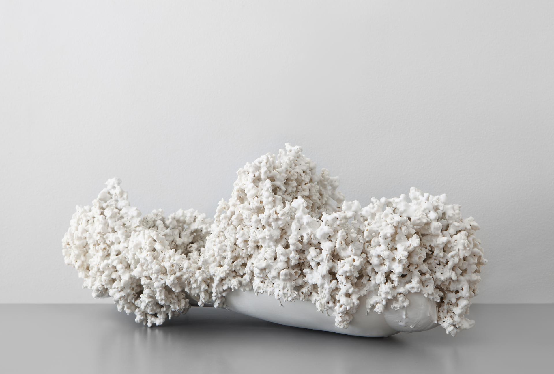 Artistic white coral sculpture displayed on a sleek surface, highlighting unique design elements from independent creators at the London Design Fair.