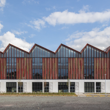 Modern building with a distinctive patterned facade, showcasing creative retrofit design for sustainability in architecture.