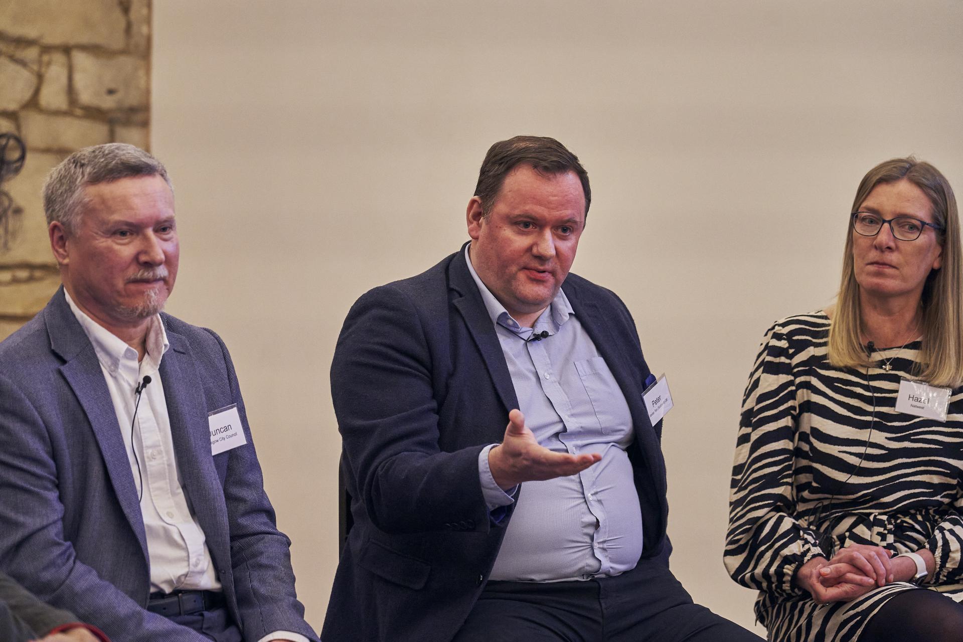 Panel discussion on sustainability featuring three speakers during an event at Material Source Studio in Glasgow.