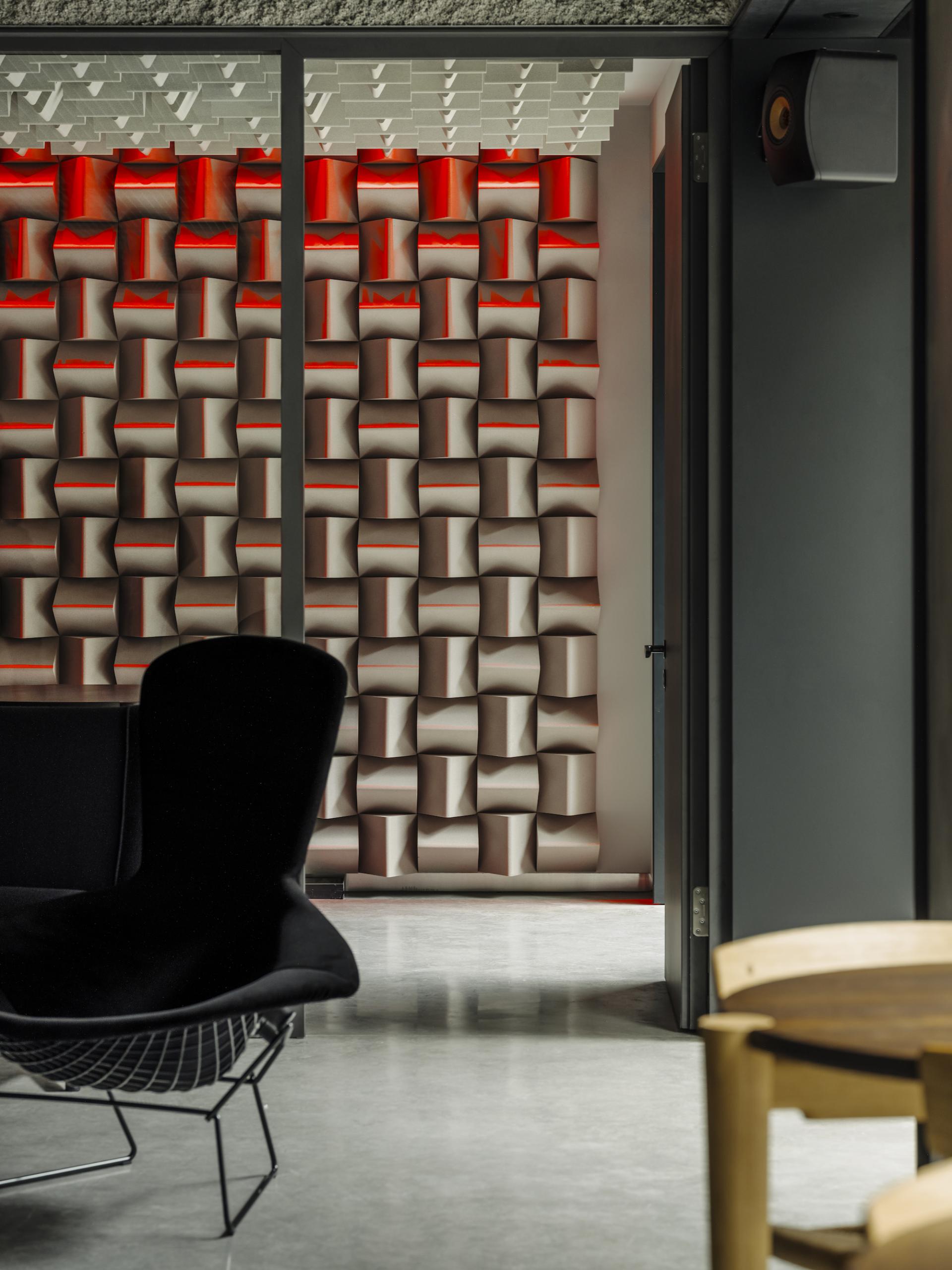 Modern interior of KEF Music Gallery in London featuring acoustic wall design and stylish seating arrangements.