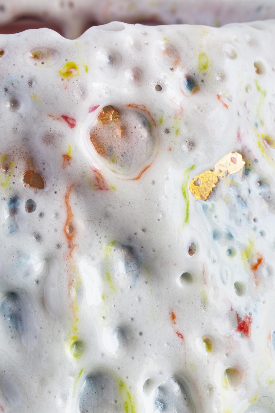 Close-up of Coralla Maiuri's new Bottega d’Arte vase showcasing iridescent effects and colorful speckled textures.