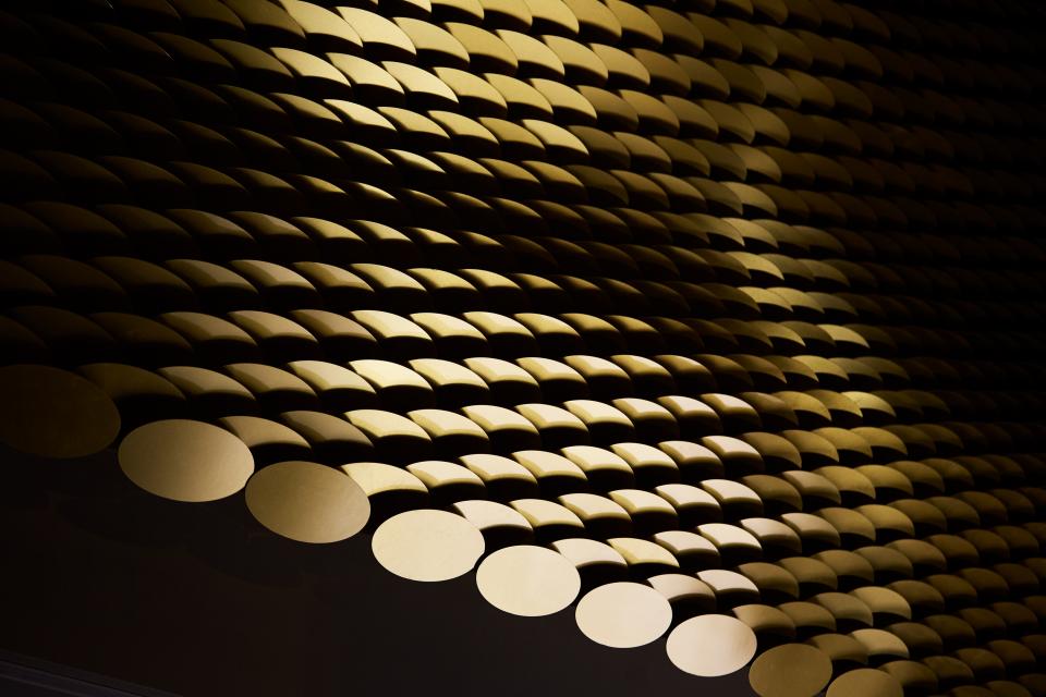 Brass louvres arranged in an intricate pattern, showcasing the architectural artistry of Giles Miller's The Veil.