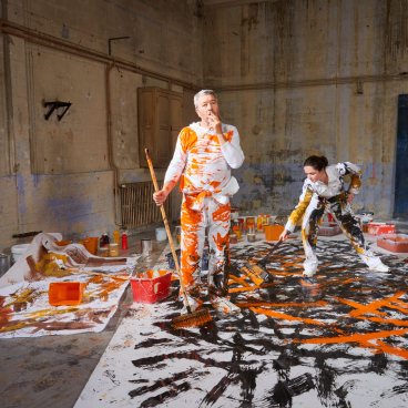 Artists working collaboratively in a studio, creating a vibrant painting with bold colors for Forbo's new Flotex collection.