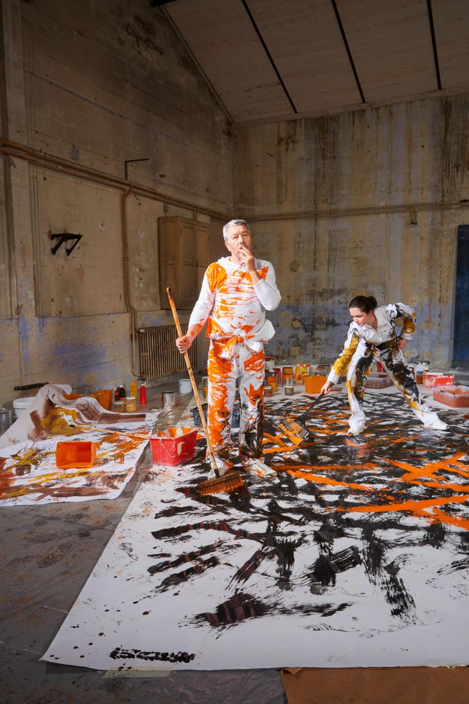 Artists working collaboratively in a studio, creating a vibrant painting with bold colors for Forbo's new Flotex collection.