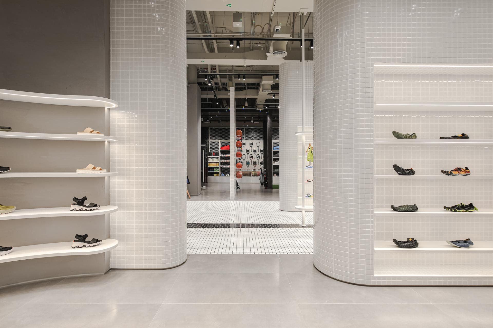 Brightly lit underground sports store showcasing sleek shelves of vibrant activewear shoes against a modern minimalist backdrop.