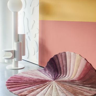 Textured circular rug in vibrant colors positioned in a stylish interior, showcasing the Kitty Joseph x FLOOR_STORY collaboration.