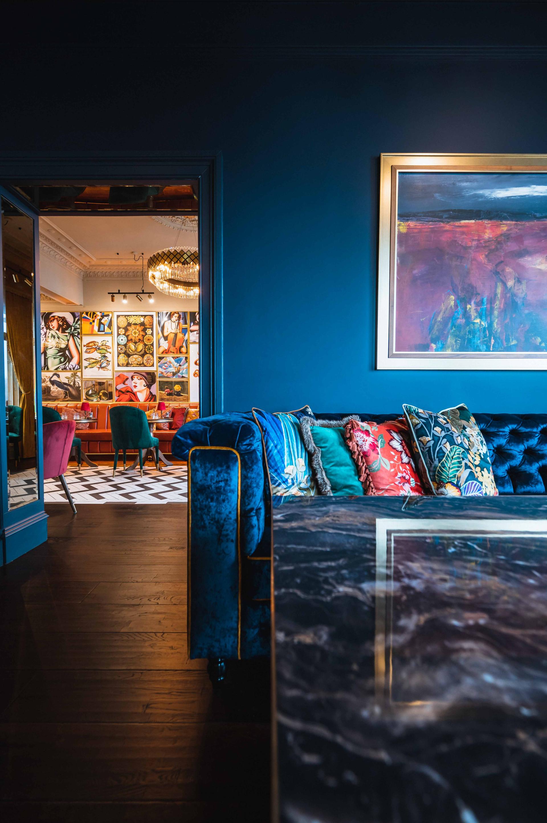 Chic interior of a boutique hotel in Oban featuring decorative pillows, art, and stylish furnishings.