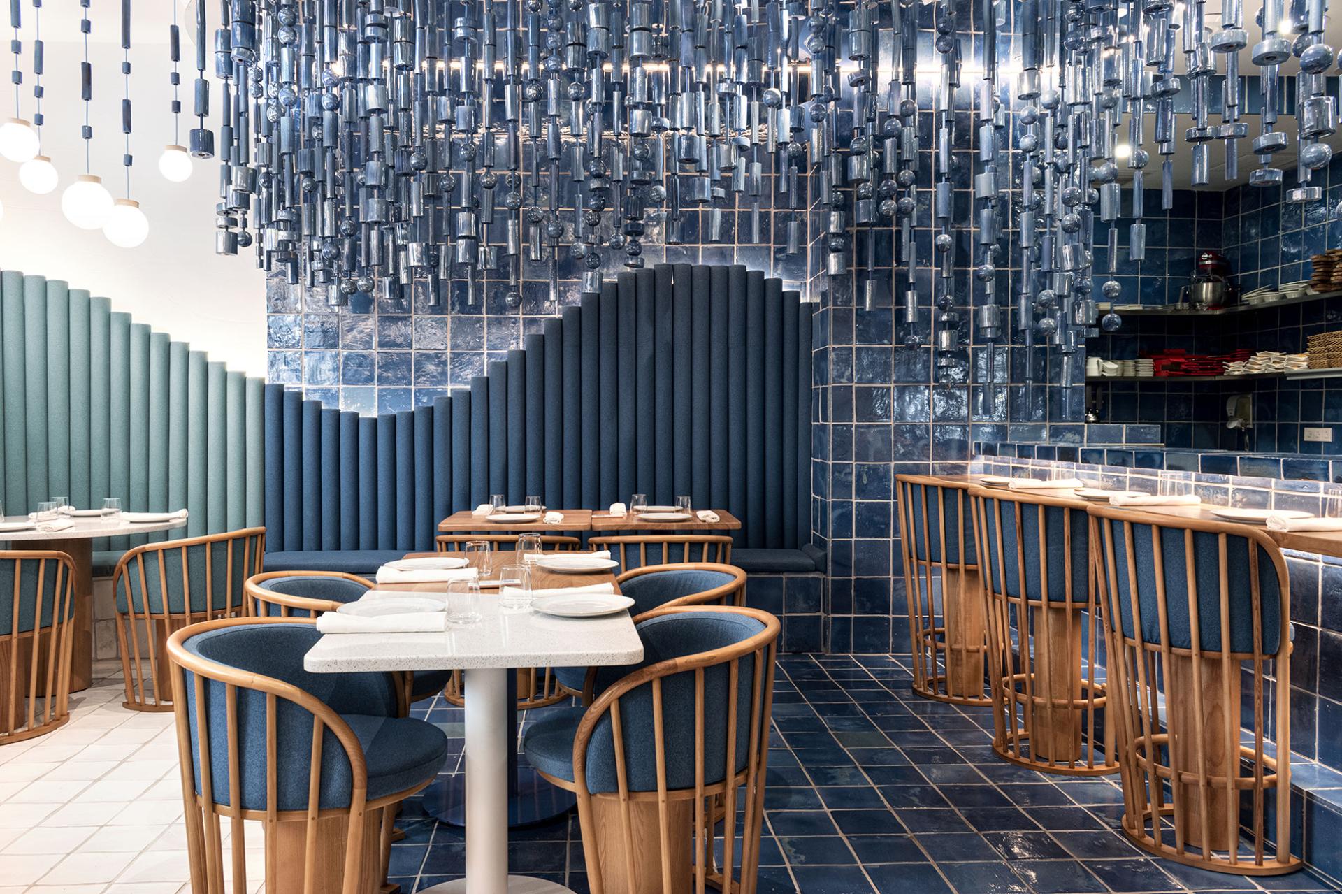 Interior view of La Sastrería restaurant in Valencia, showcasing elegant blue tones and modern design elements.