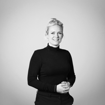 Creative Director Sarah Dodsworth poses confidently in a black turtleneck, highlighting her role in interior design and local culture.