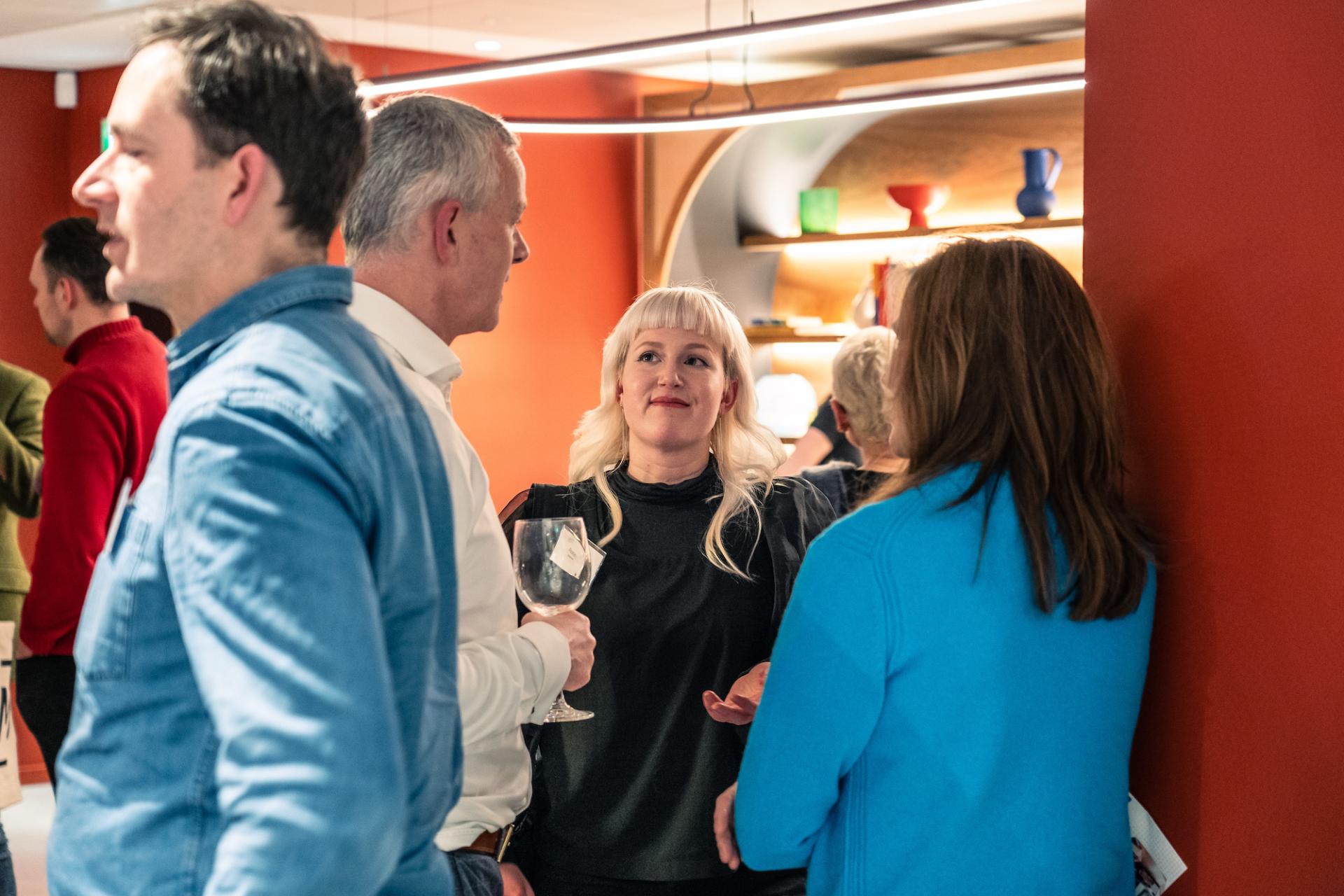 Attendees engage in conversation at Material Source Studio in Glasgow, focusing on sustainability and its real costs.