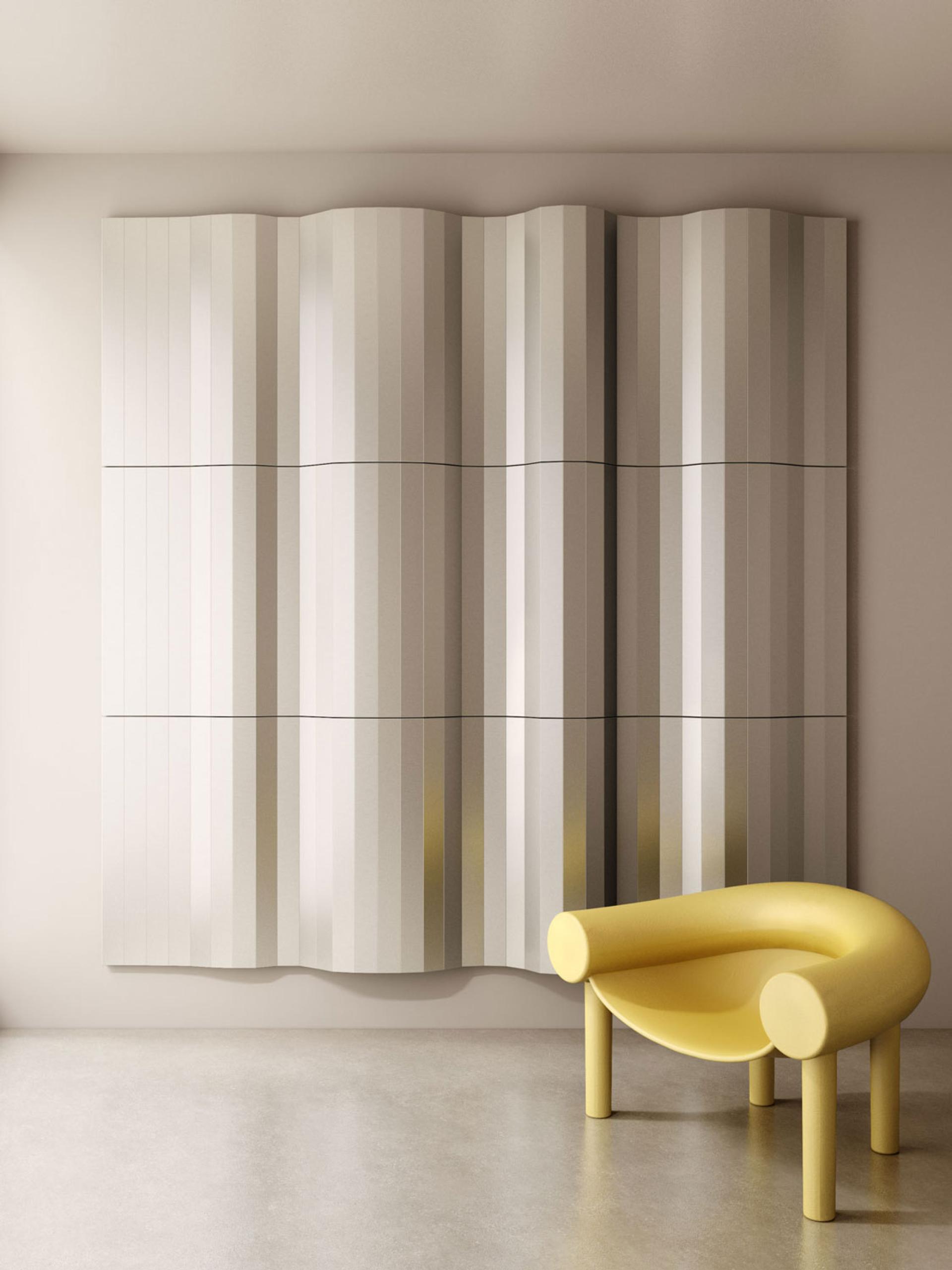 Newly designed Fold Panels with a wavy pattern showcased beside a distinctive yellow chair in a modern interior space.