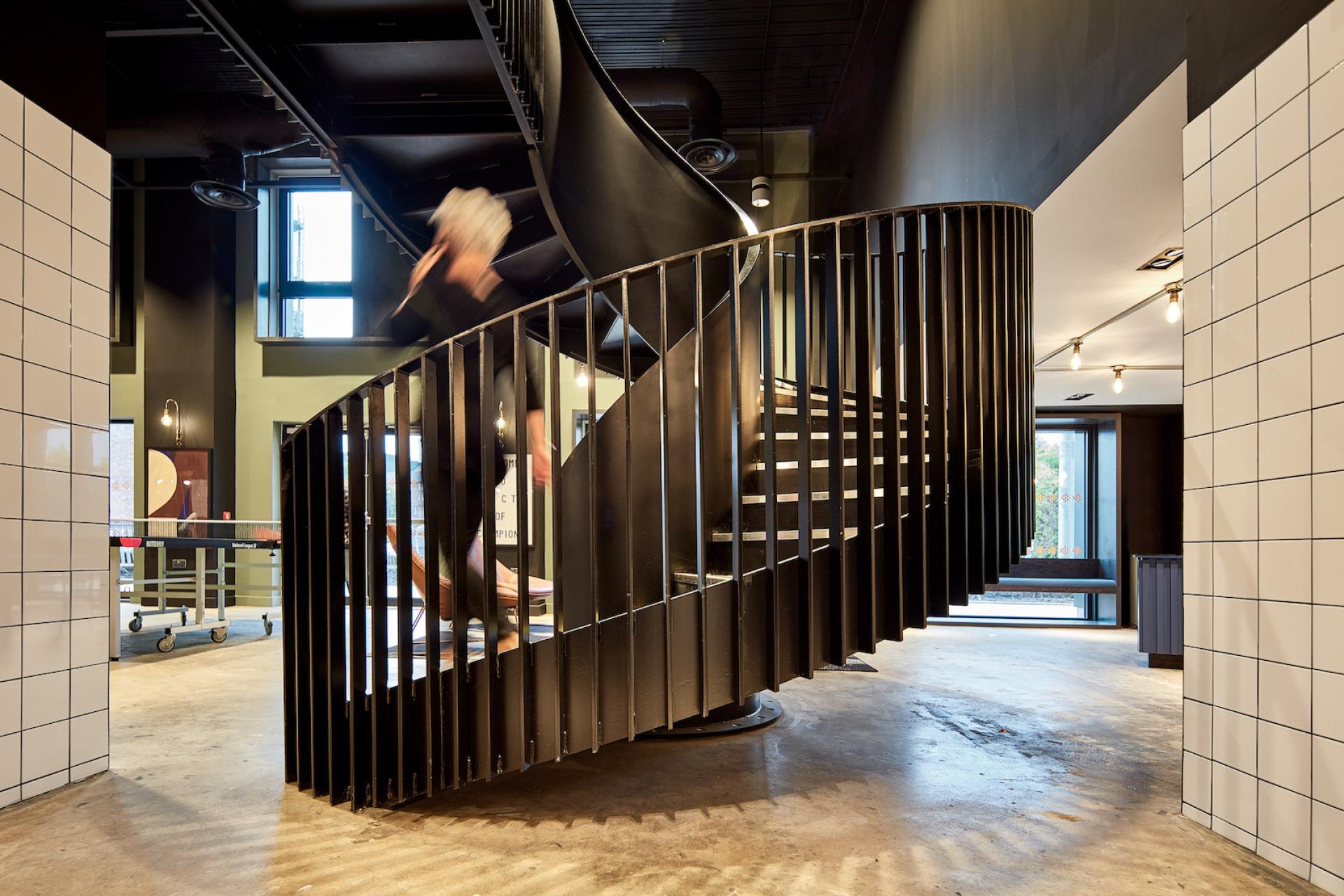 Spiral staircase with modern design elements in a stylish interior, showcasing innovative architecture and creative use of space.