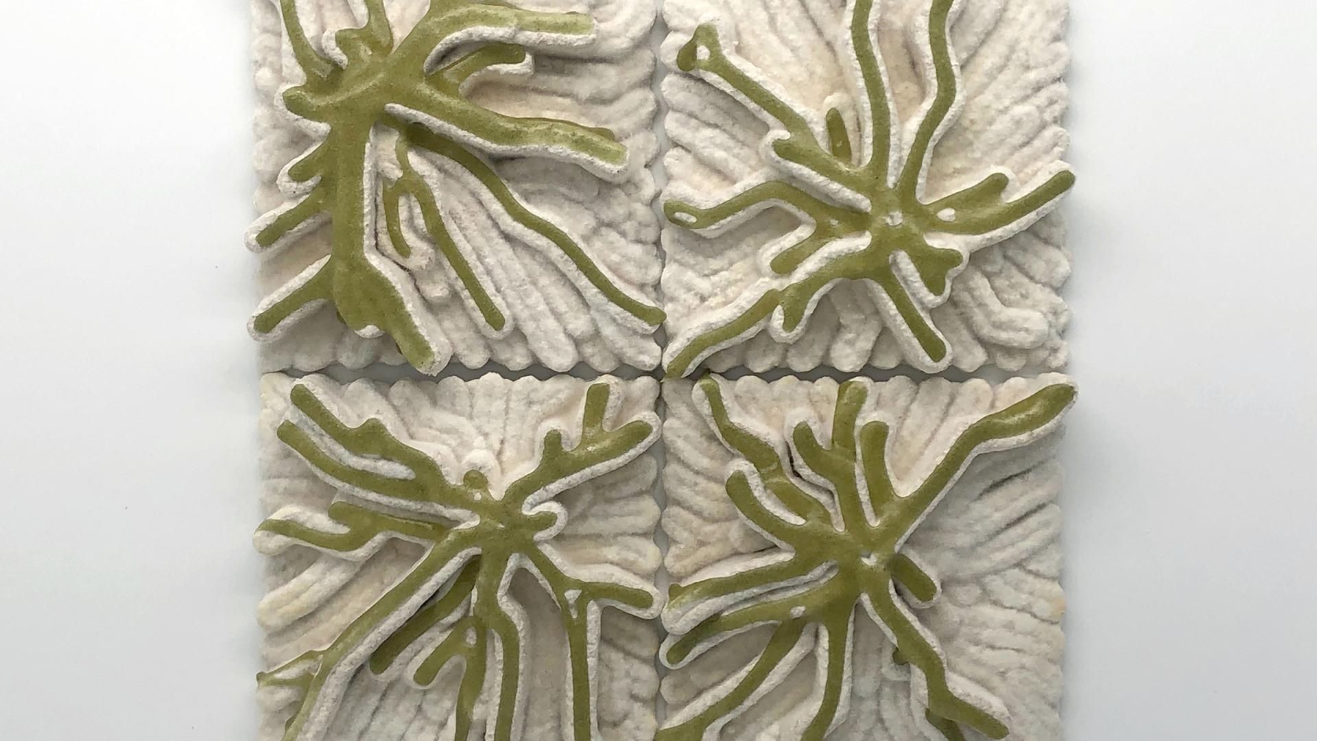 Textured tiles made of 3D-printed mycelium and algae, showcasing an innovative bio-material design for interior spaces.