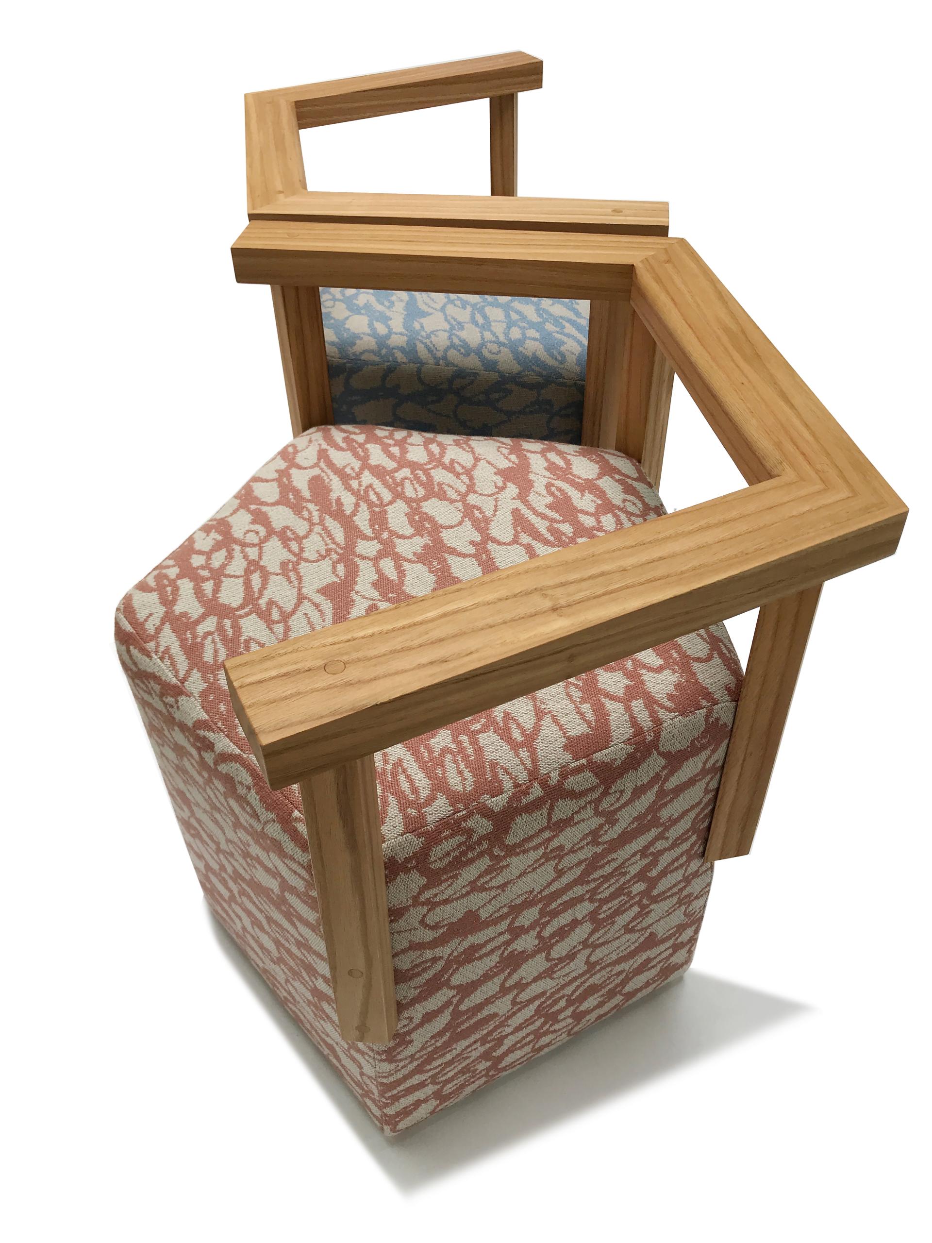 A unique chair featuring British wool upholstery with a modern wooden frame, highlighting sustainable design and craftsmanship.