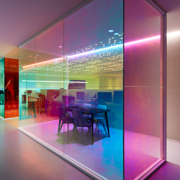 Vibrant, light-filled office space featuring optical prisms creating a colorful atmosphere at Ambience by Studio Y.