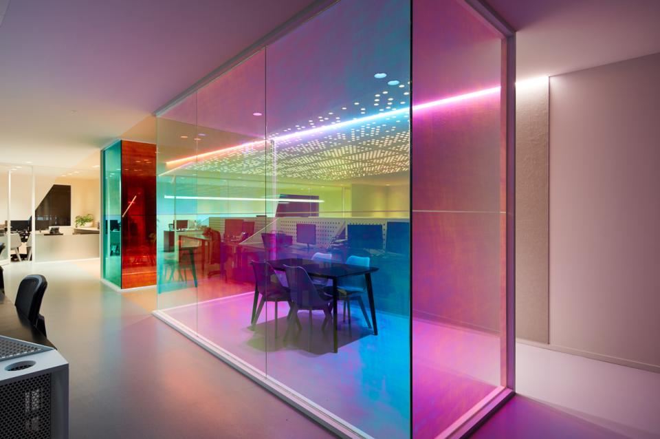 Vibrant, light-filled office space featuring optical prisms creating a colorful atmosphere at Ambience by Studio Y.