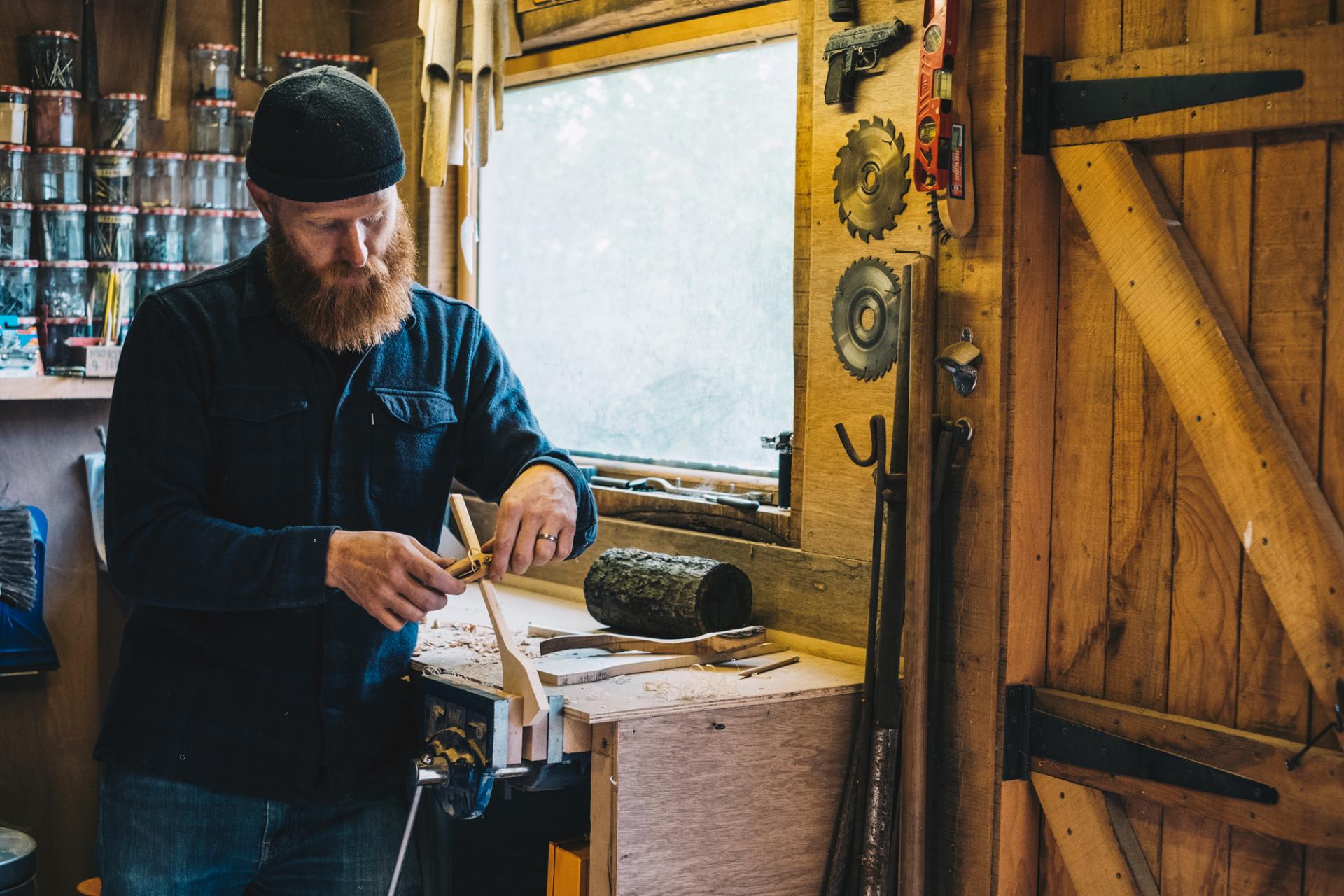 Pete Hill crafting furniture in his workshop, showcasing woodworking tools and natural materials, celebrating local craftsmanship.