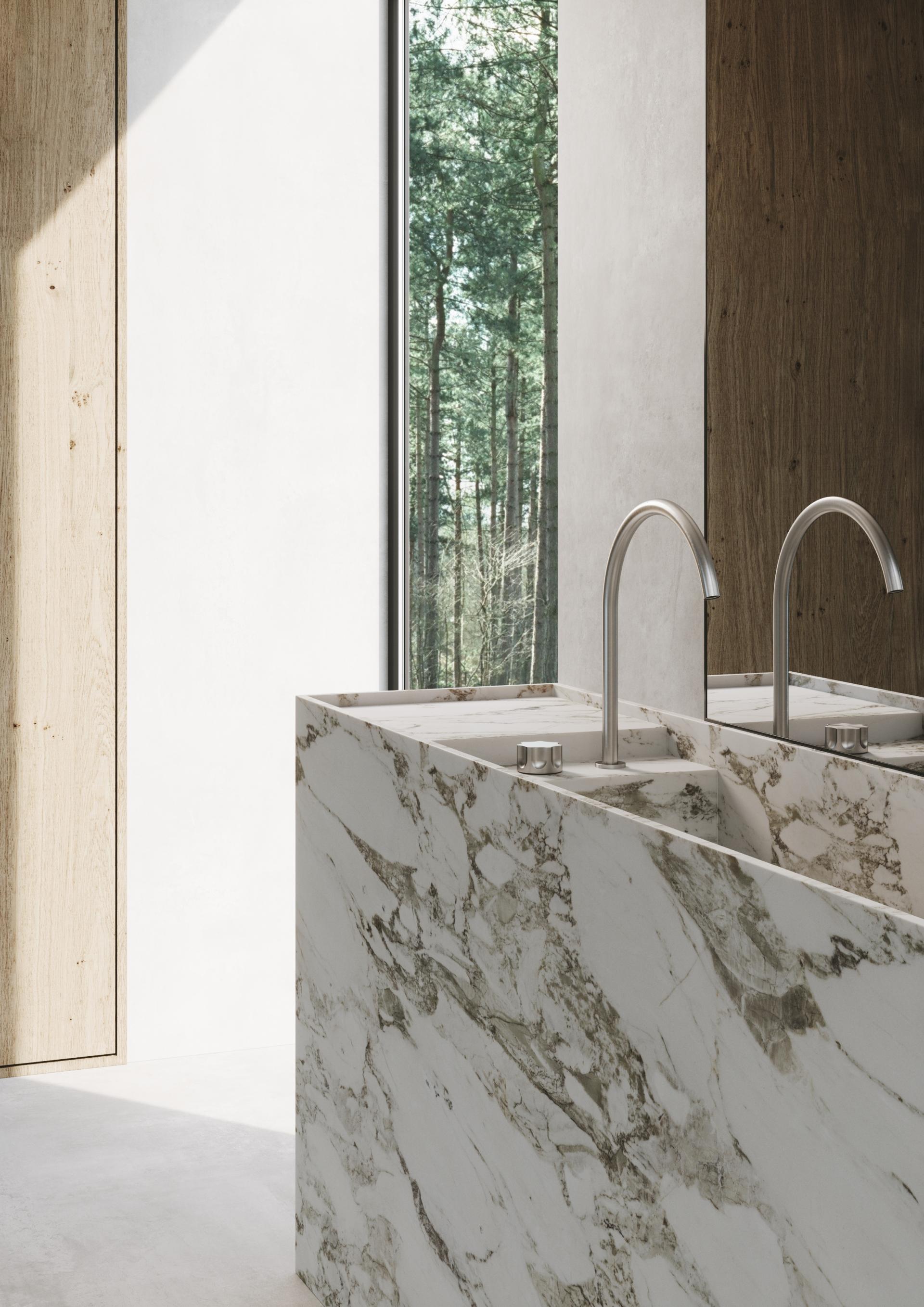 Sleek marble sink with modern fixtures, showcasing Quadro Design Italy's innovative bathroom products in a minimalist setting.