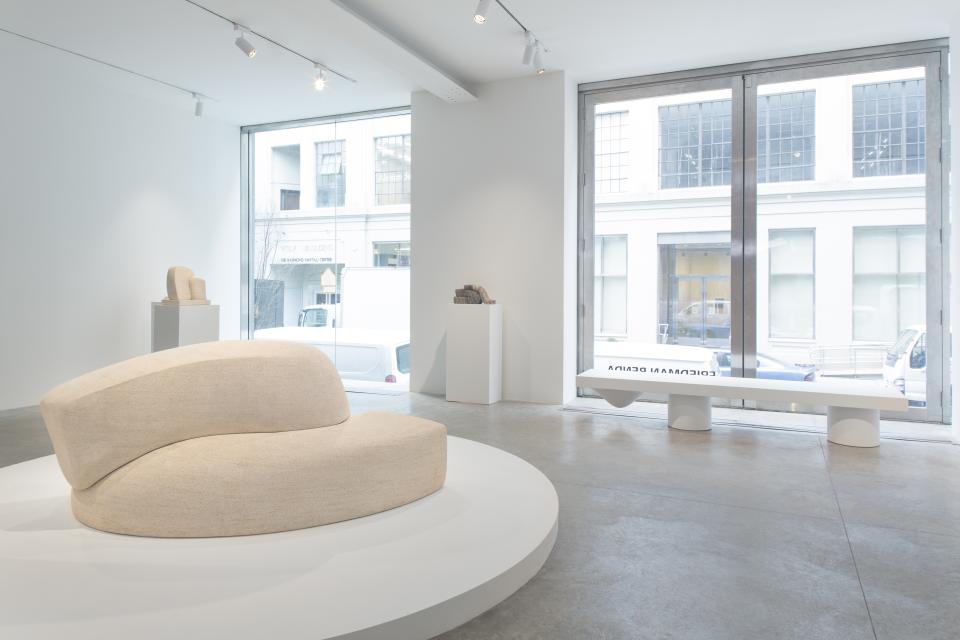 Contemporary interior view showcasing Wendell Castle's sculptural furniture, including an organic-shaped sofa and minimalist bench.