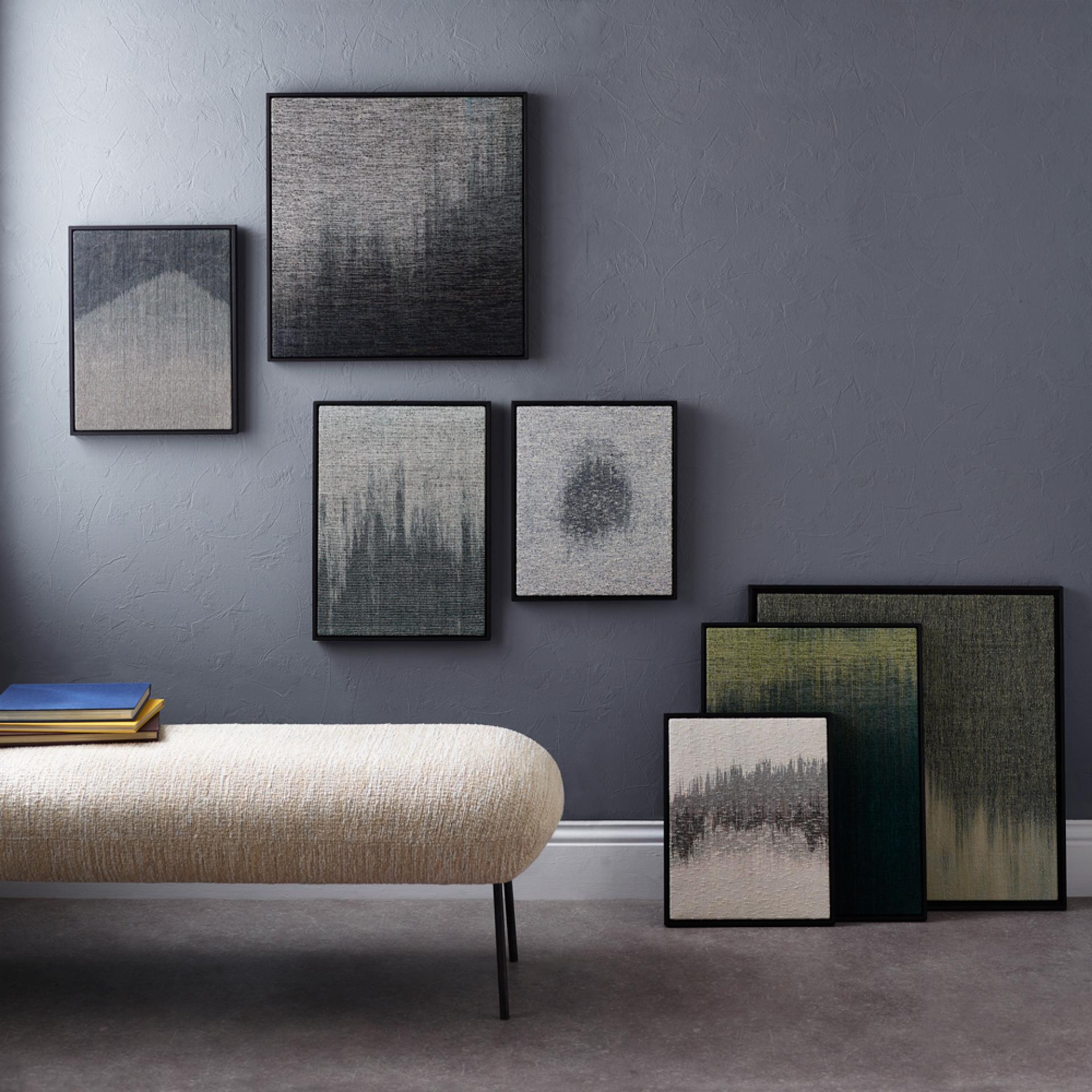 Textured wall art in frames, showcasing contemporary craft designs, complemented by a cozy fabric bench in Nottingham.