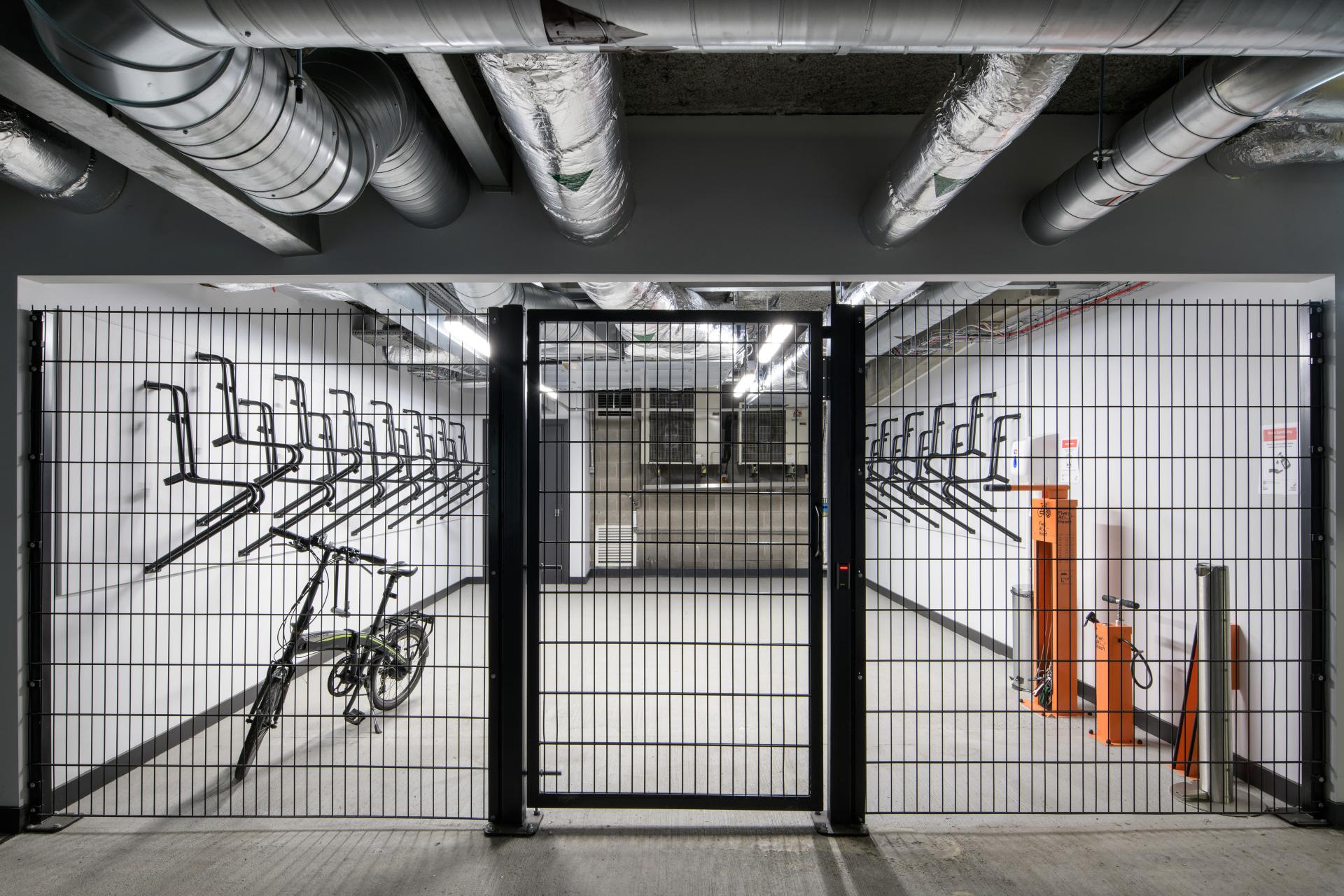 Bicycle storage area featuring bike racks, a bike, and modern design elements in Manchester's One Piccadilly Gardens.
