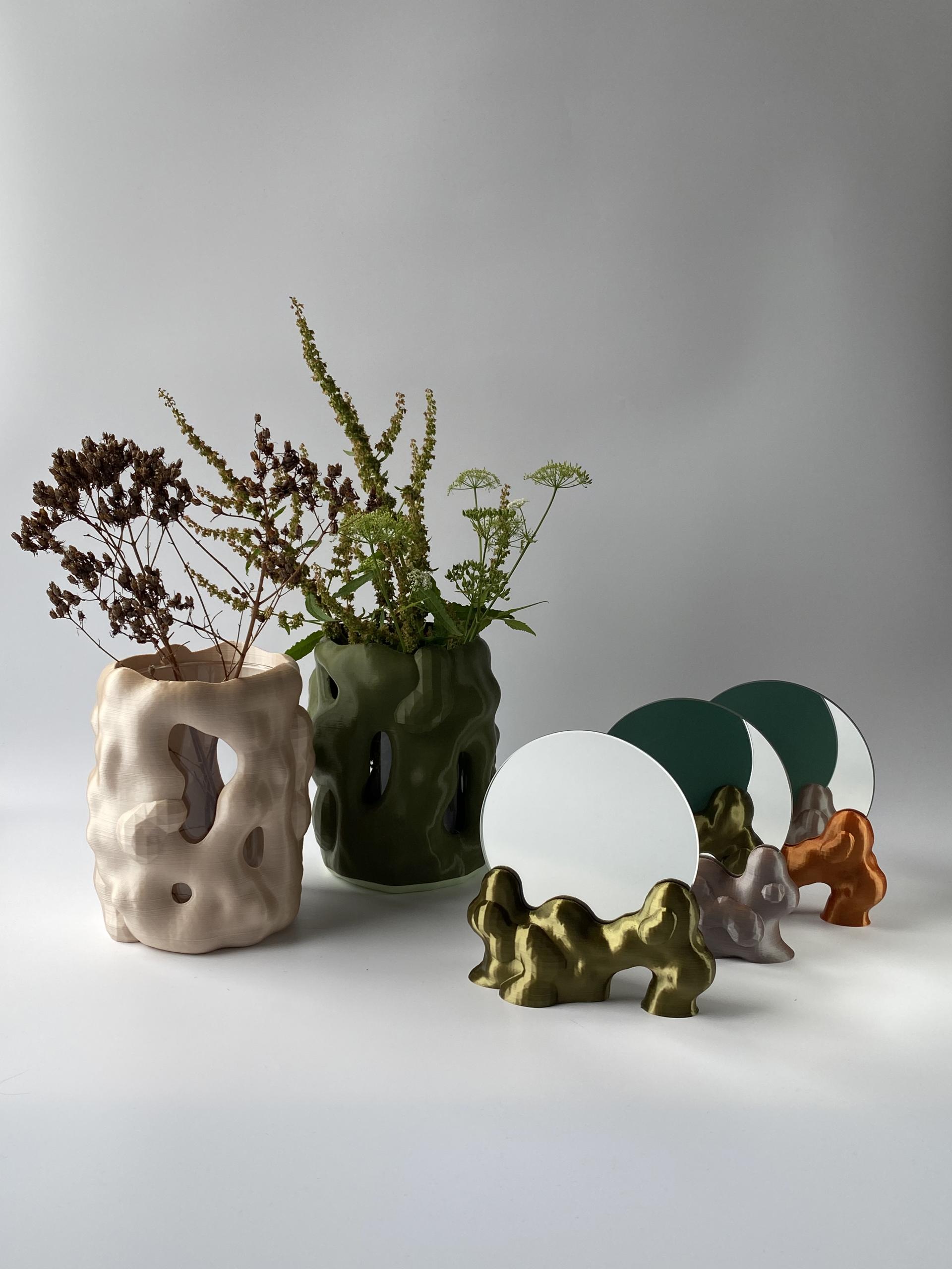 Stylish 3D-printed vases and mirrors by Soorin Shin, showcasing innovative design and new media art with floral arrangements.