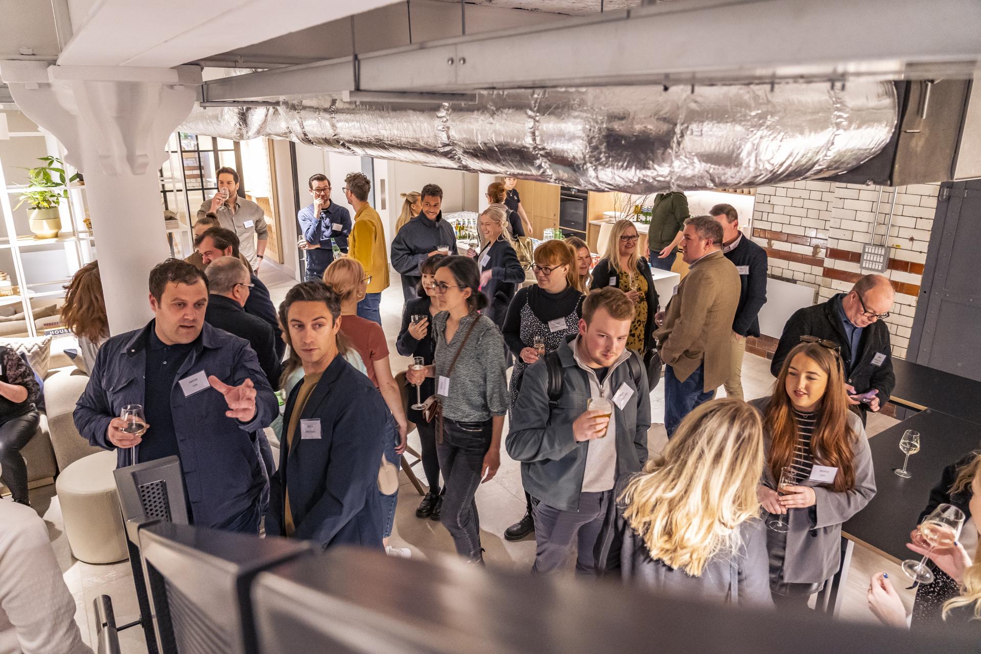 Attendees networking and socializing during the Material Source Studio seminar on fire safety and design concepts.