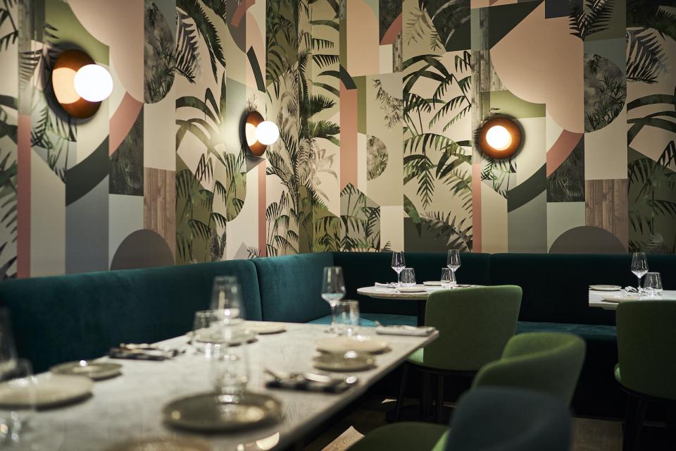 Vibrant restaurant interior featuring unique wallpaper designs from Bespoke Atelier, showcasing modern decor and stylish lighting.