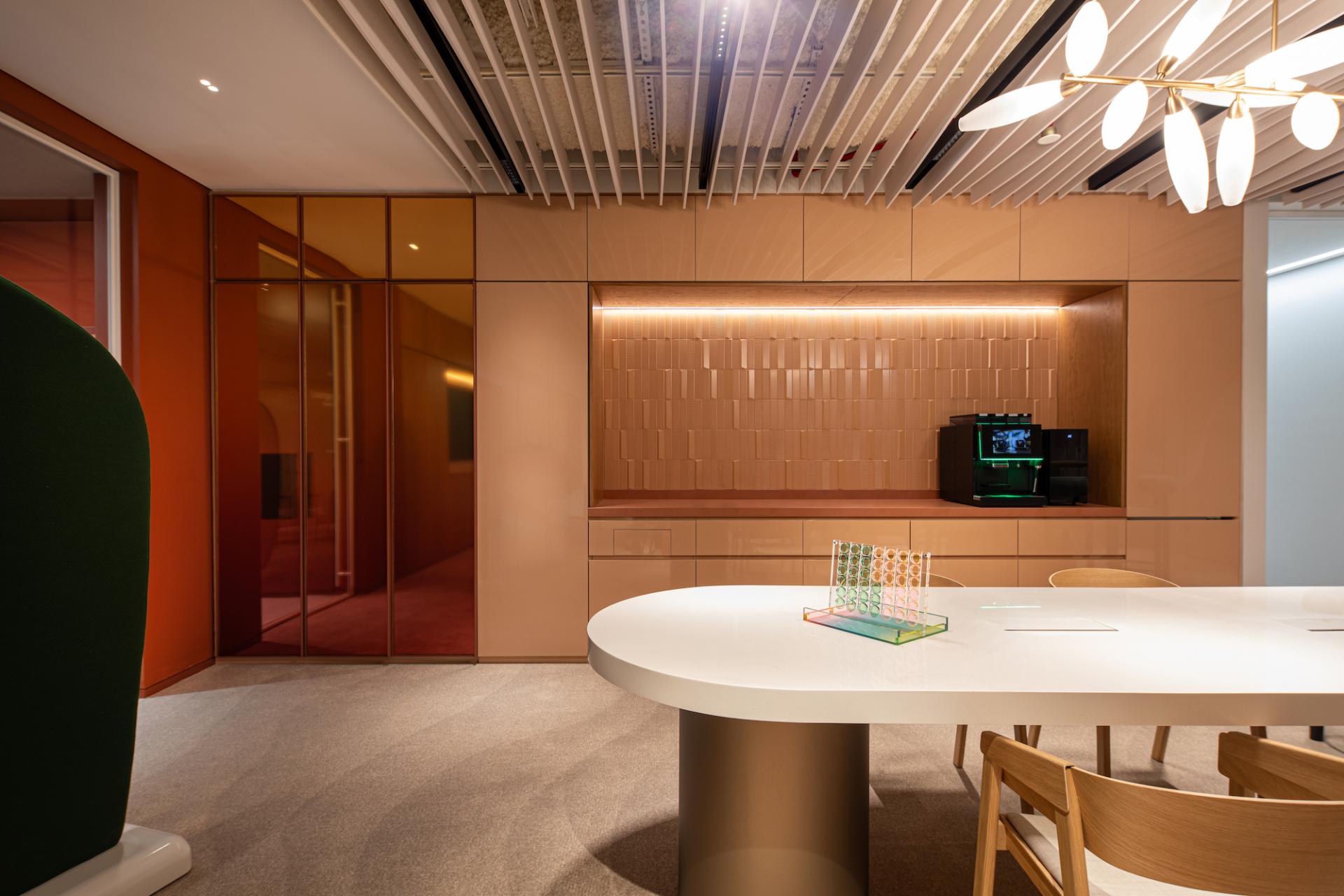 Brightly colored modern workplace in Dubai featuring a stylish meeting area and a coffee station, inspired by nature.