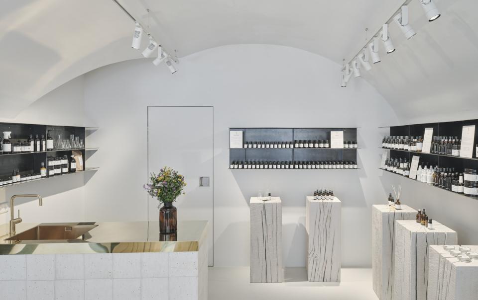 Modern store interior of Saint Charles featuring natural cosmetics, minimalist design with wooden displays and elegant decor.