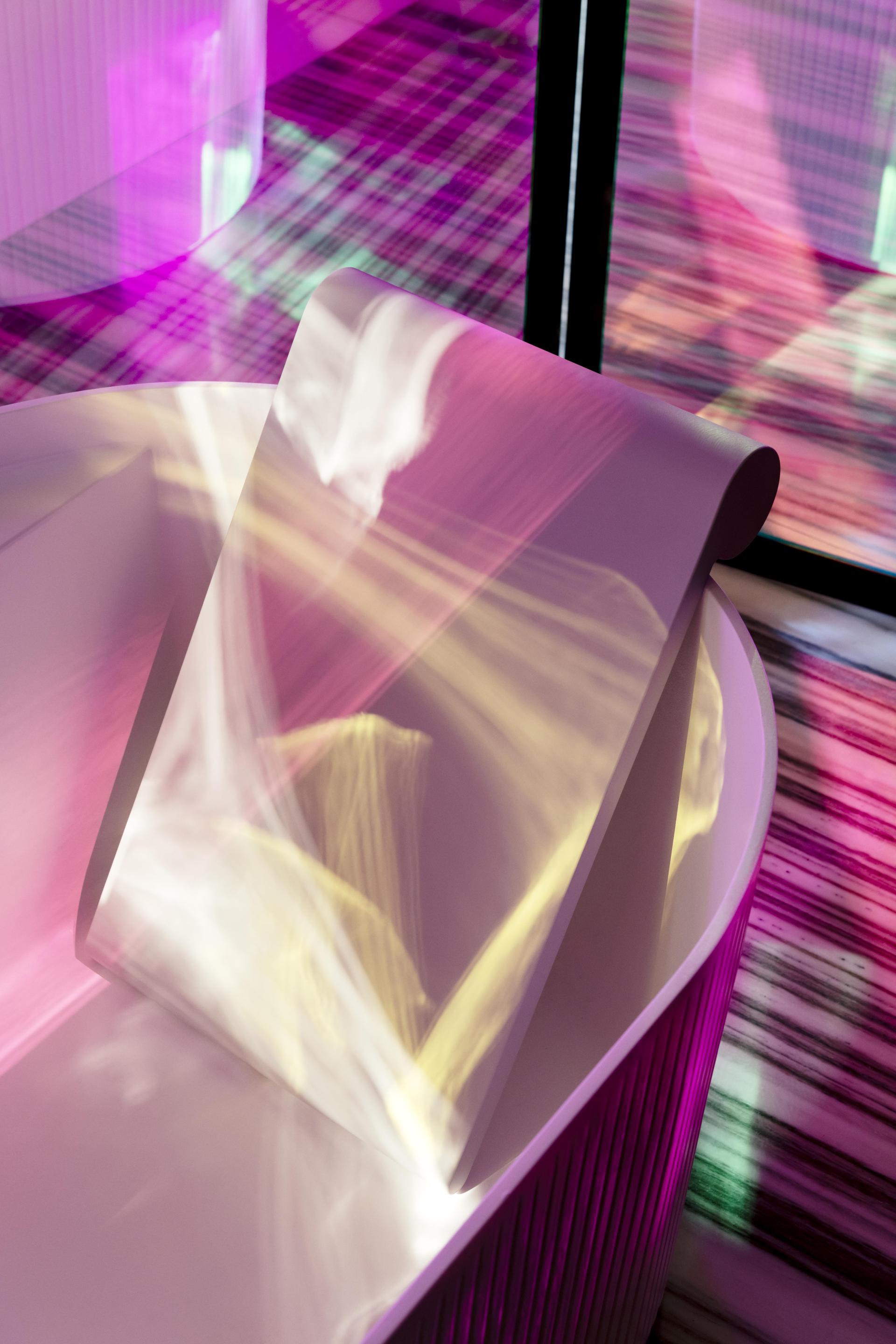 Elegant LAUFEN bathtub showcasing modern design with vibrant light reflections creating a serene ambiance.