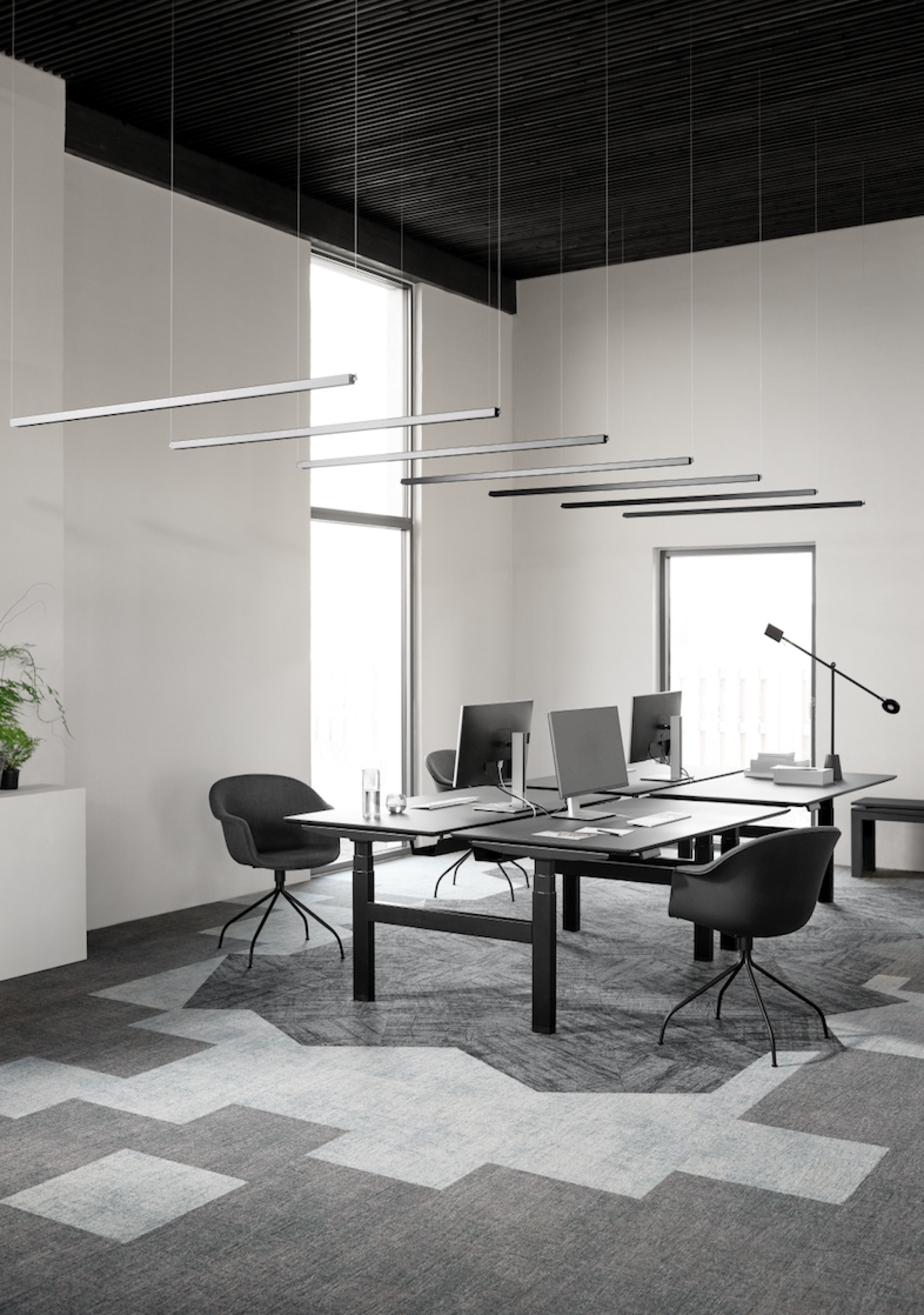 Modern office space featuring Ege Carpets' sustainable Mark of Time Ecotrust collection with minimalist design and natural lighting.