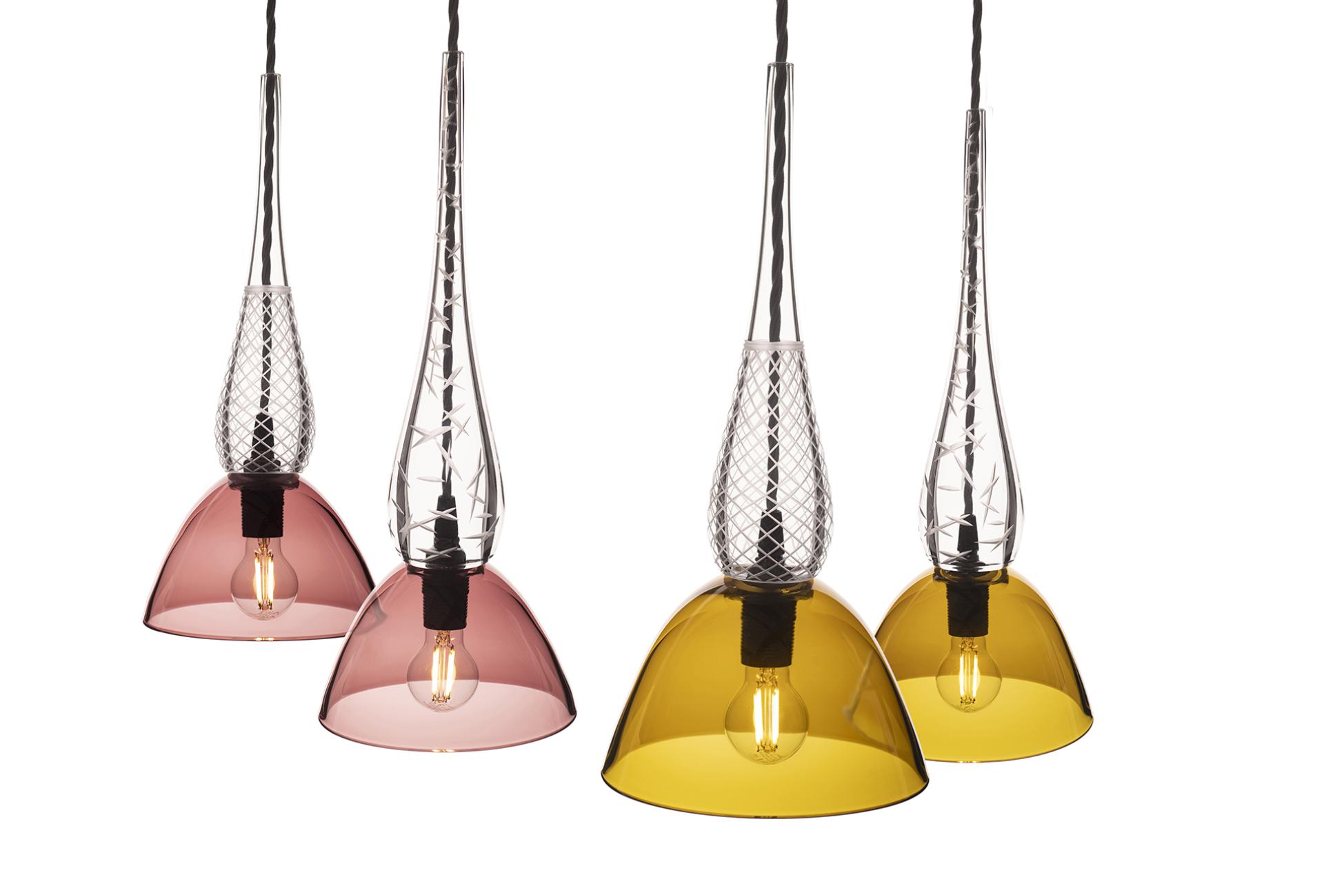 Elegant pendant lights in pink and yellow glass showcasing contemporary British design, reflecting Nicola Schellander's innovative craft.