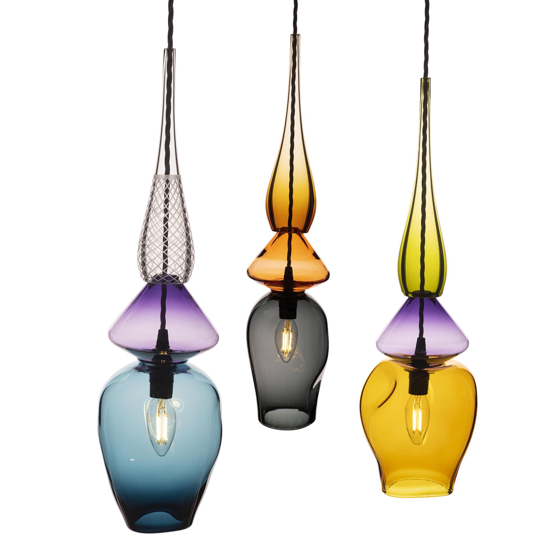 Three beautifully crafted glass pendant lights in vibrant colors showcasing modern British design by Nicola Schellander.