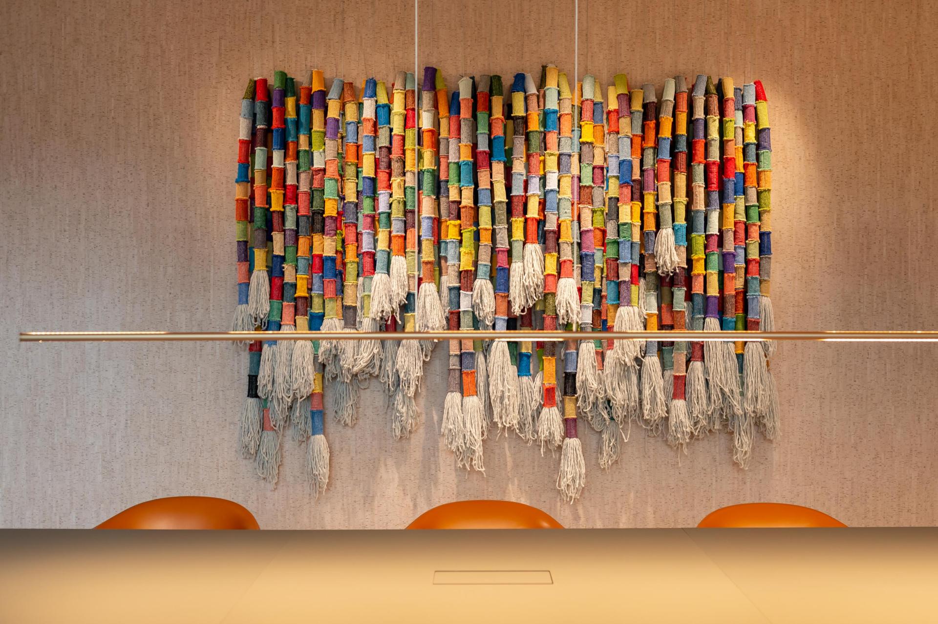 Colorful textile artwork by Anna Ray, featuring vibrant threads and tassels, celebrating London's weaving heritage.