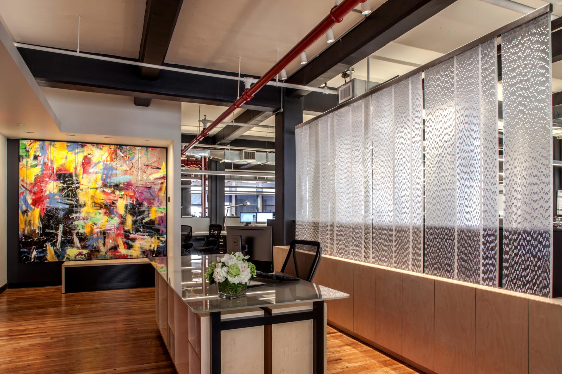 Vibrant office interior featuring an abstract painting, sustainable materials, and a stylish reception area design.