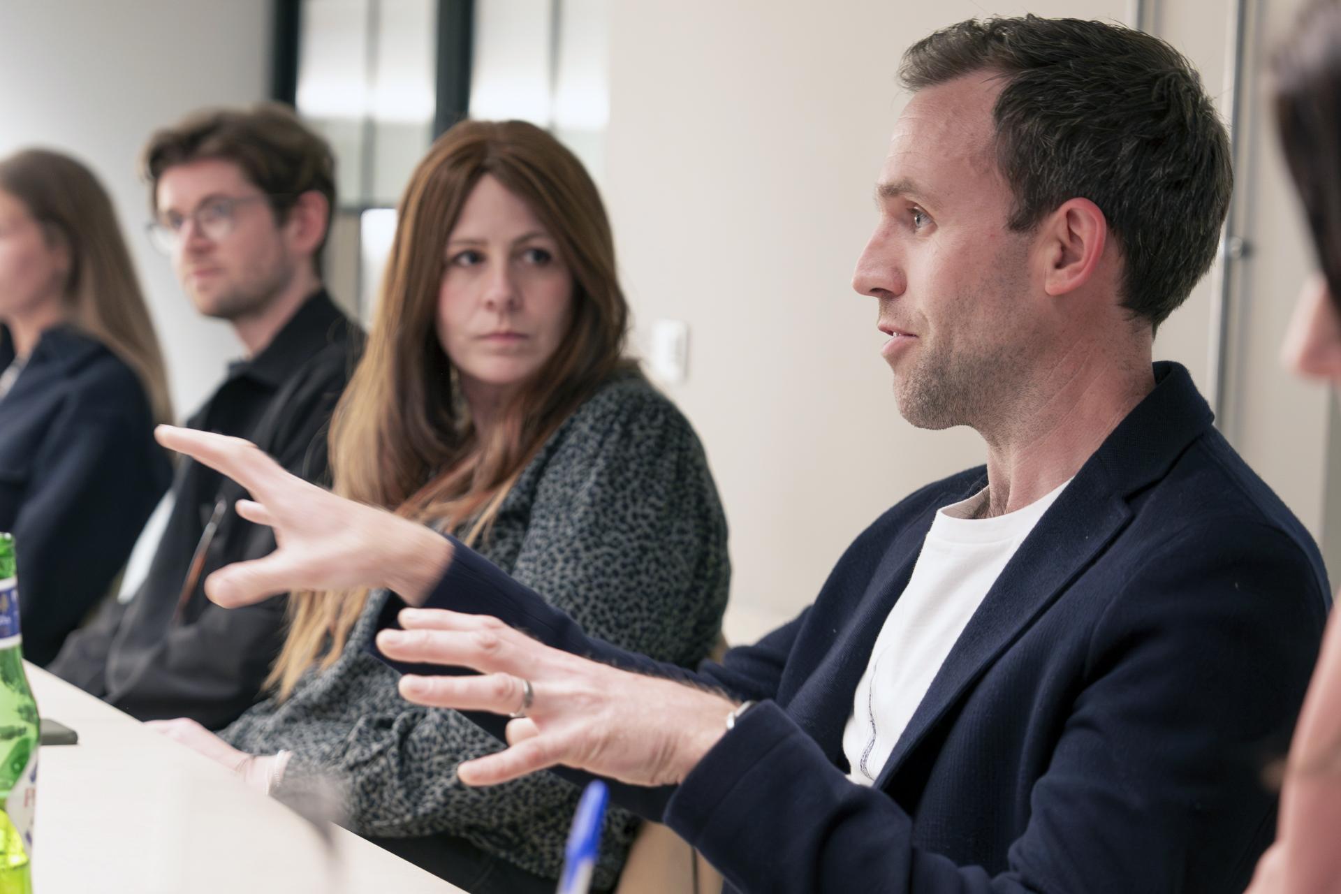 Participants engage in discussion at a Manchester property seminar, exploring residential mix and urban development issues.