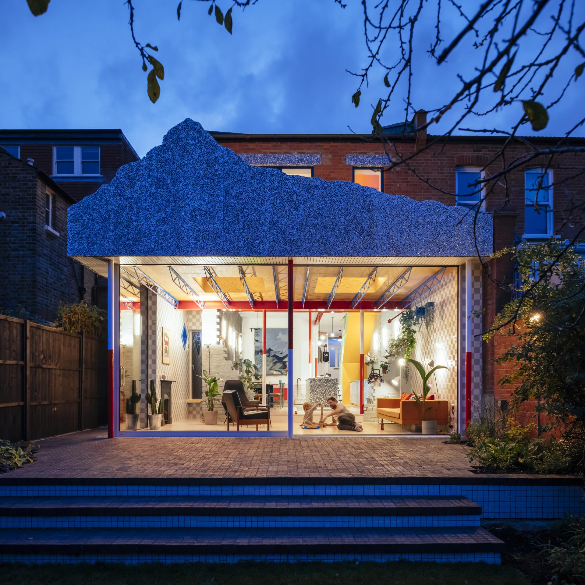 Colourful Edwardian house renovation by London architecture studio CAN, featuring a distinctive mountain-shaped roof design.