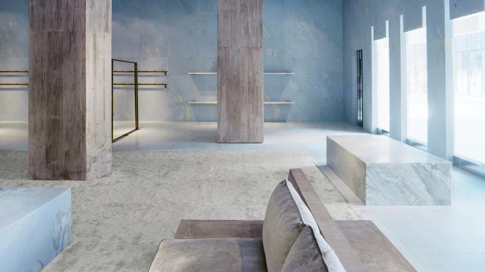 Stylish interior of Céline's Miami store featuring blue marble surfaces, minimalist design, and geometric pyramid shapes.