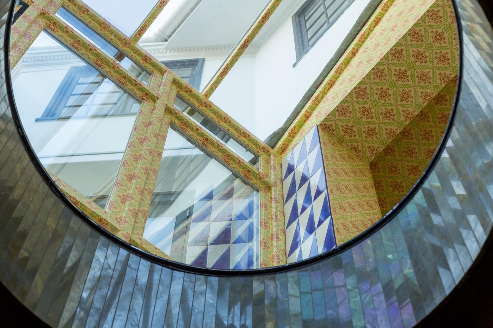 Vibrant geometric patterns and textures in interior design create a bold and inspiring atmosphere in the space.