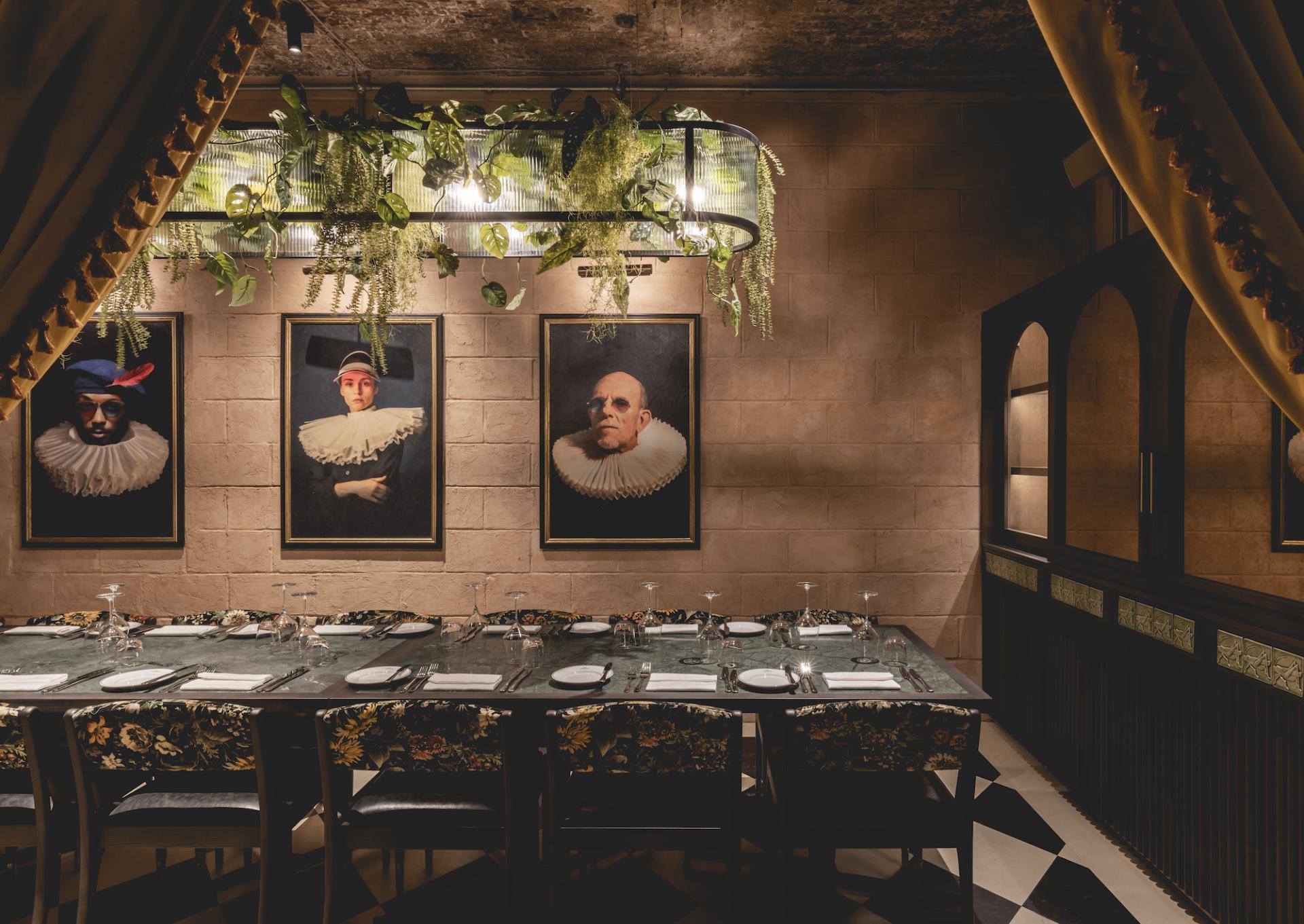 Elegant dining area in The Libertine, featuring art, greenery, and sophisticated decor in the Royal Exchange.