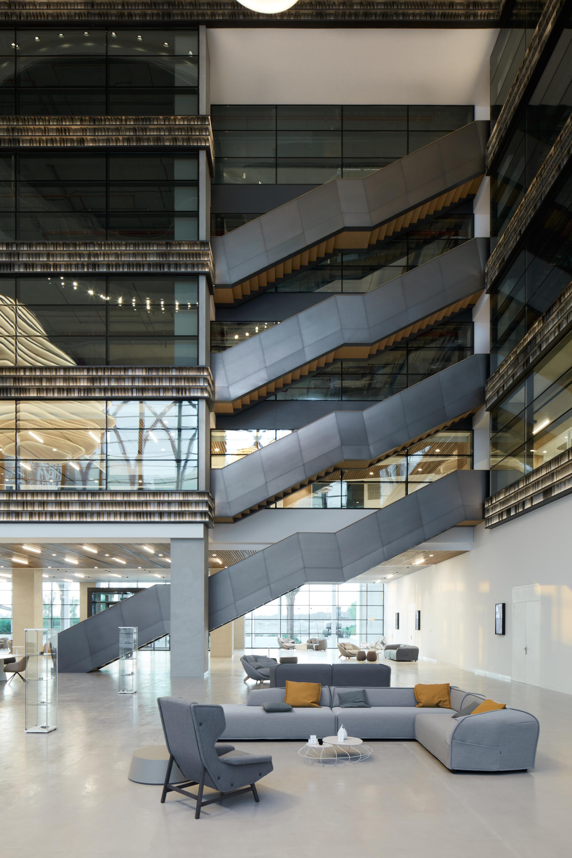 Modern interior of American University of Sharjah's Research Technology Park showcasing stylish seating and sleek staircase design.