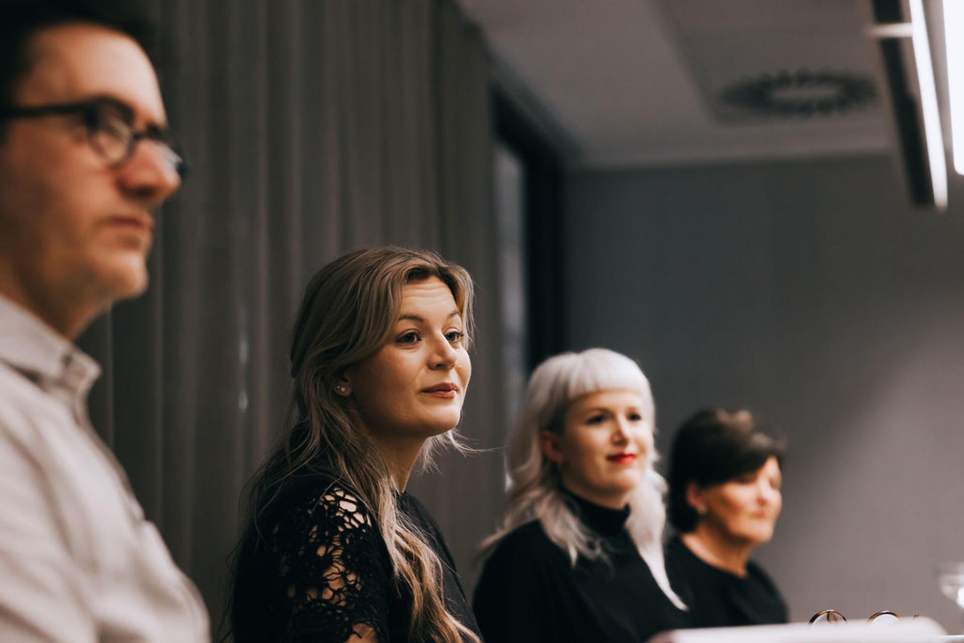 Participants engaging in a discussion about sustainability and biomaterials at an event.