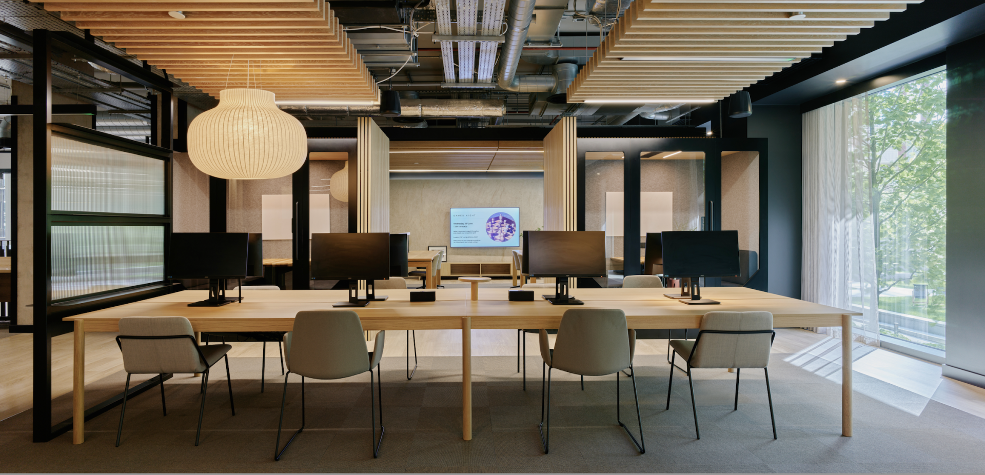 Modern co-working space featuring ergonomic desks and computer stations, showcasing Vita Group's innovative uhaus brand design.